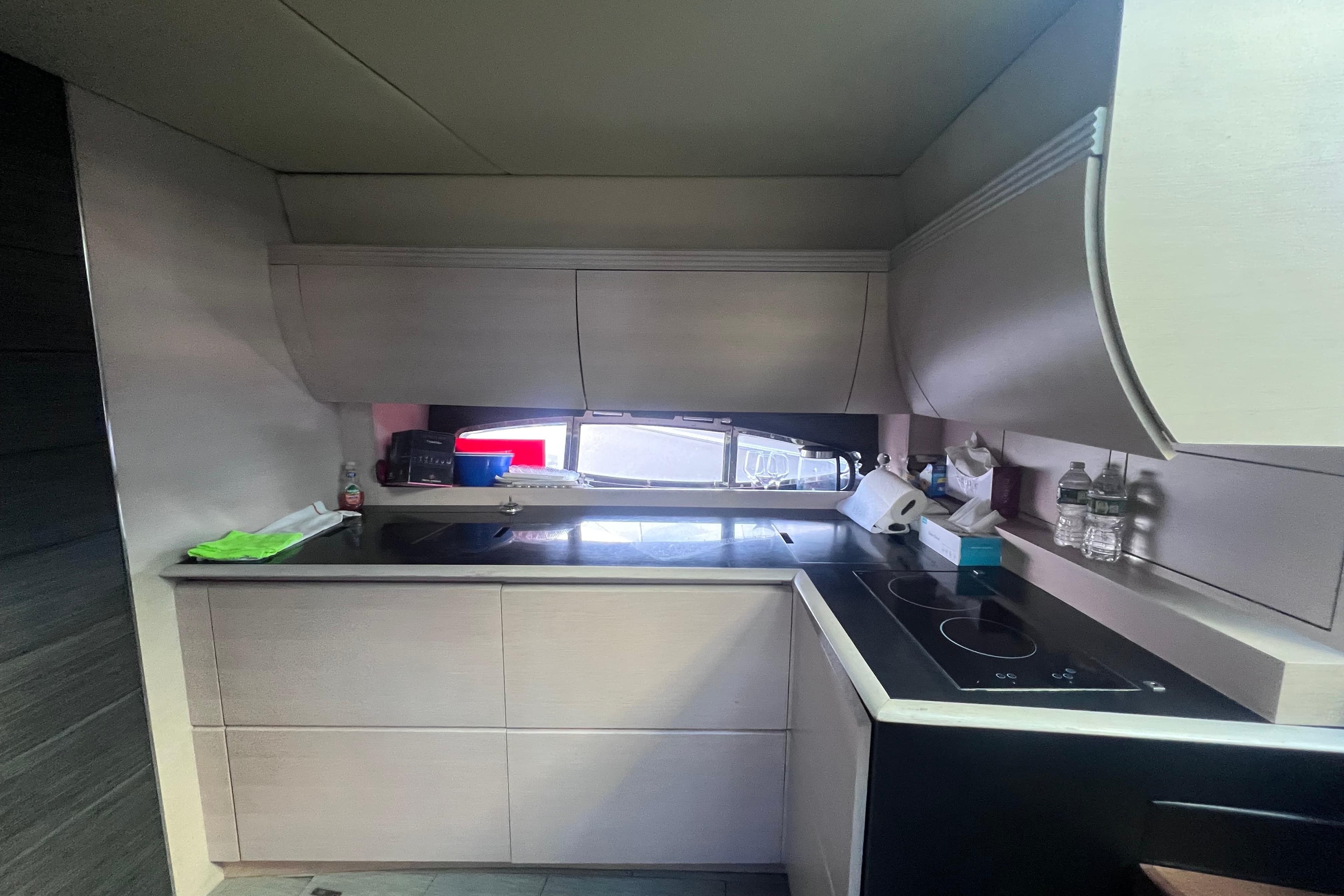 Modern kitchen interior on a 2006 Azimut Atlantis 55 yacht, featuring sleek cabinetry and appliances.