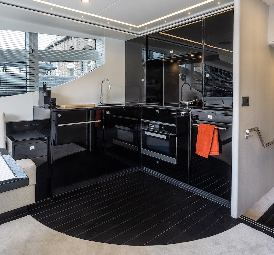 Modern kitchen interior of 2026 Van der Valk Beach Club 600 yacht with sleek black cabinetry.