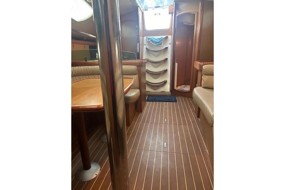 Interior of 2007 Jeanneau Sun Odyssey 42 DS sailboat with wood finish and seating area.