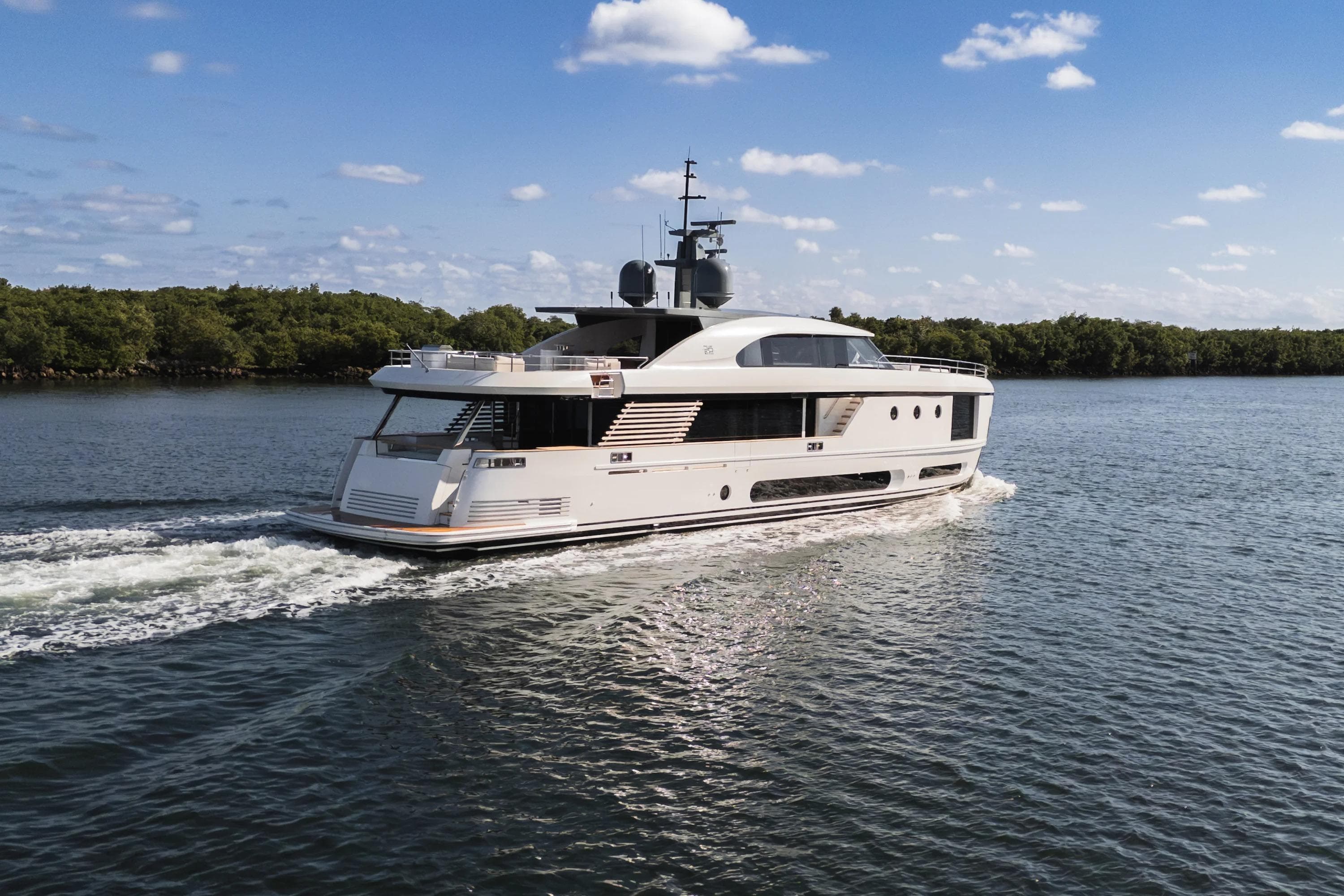 Luxury yacht Azimut Magellano 30M 2026 cruising on a serene waterway.