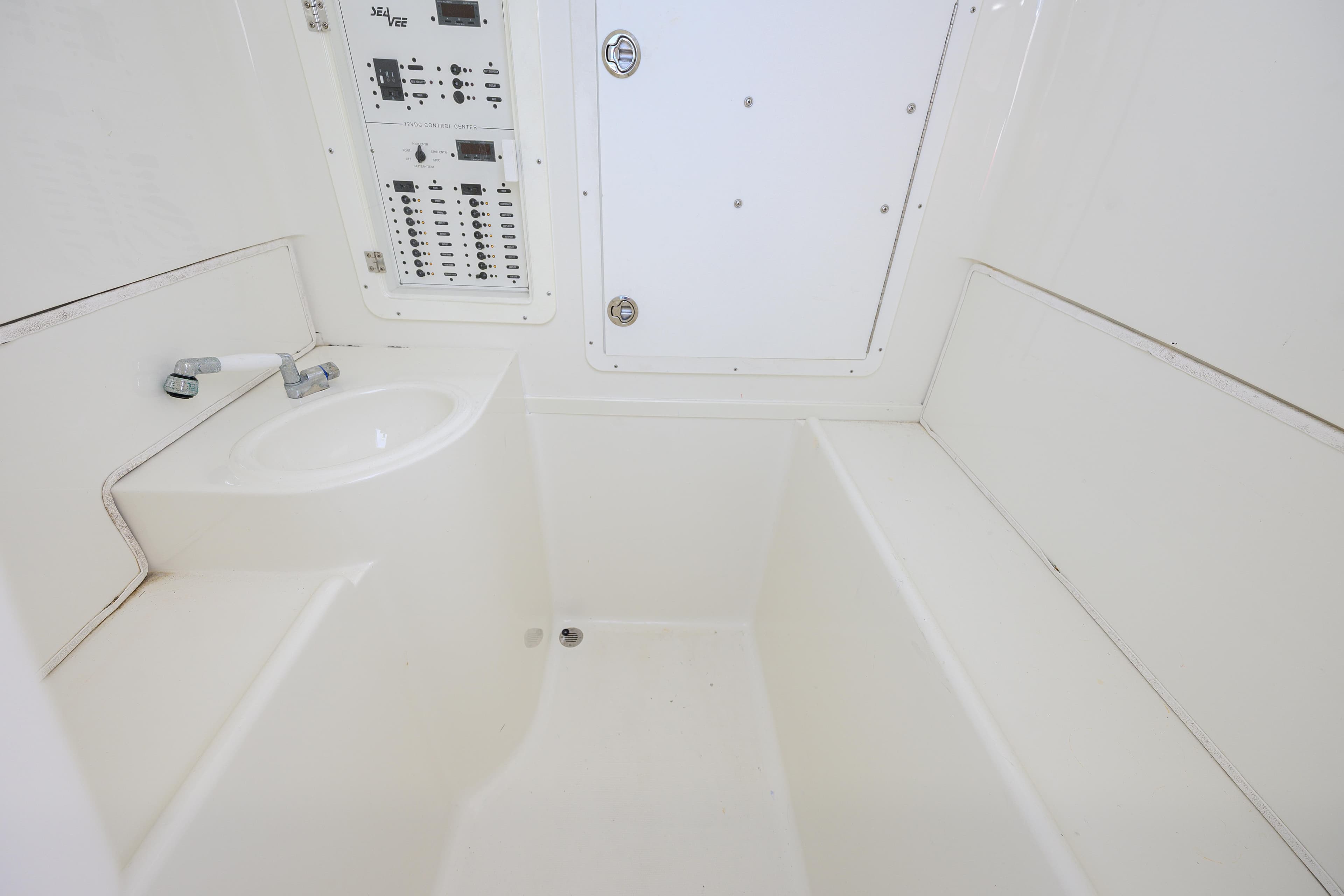 2017 SeaVee 390 interior with control panel and sink, featuring a clean, white design.