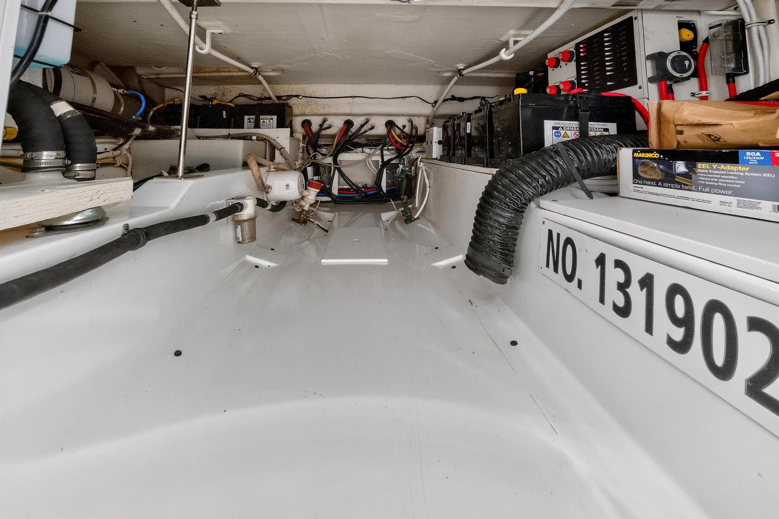 2022 Tiara Yachts 38 LX engine compartment with wiring and equipment.