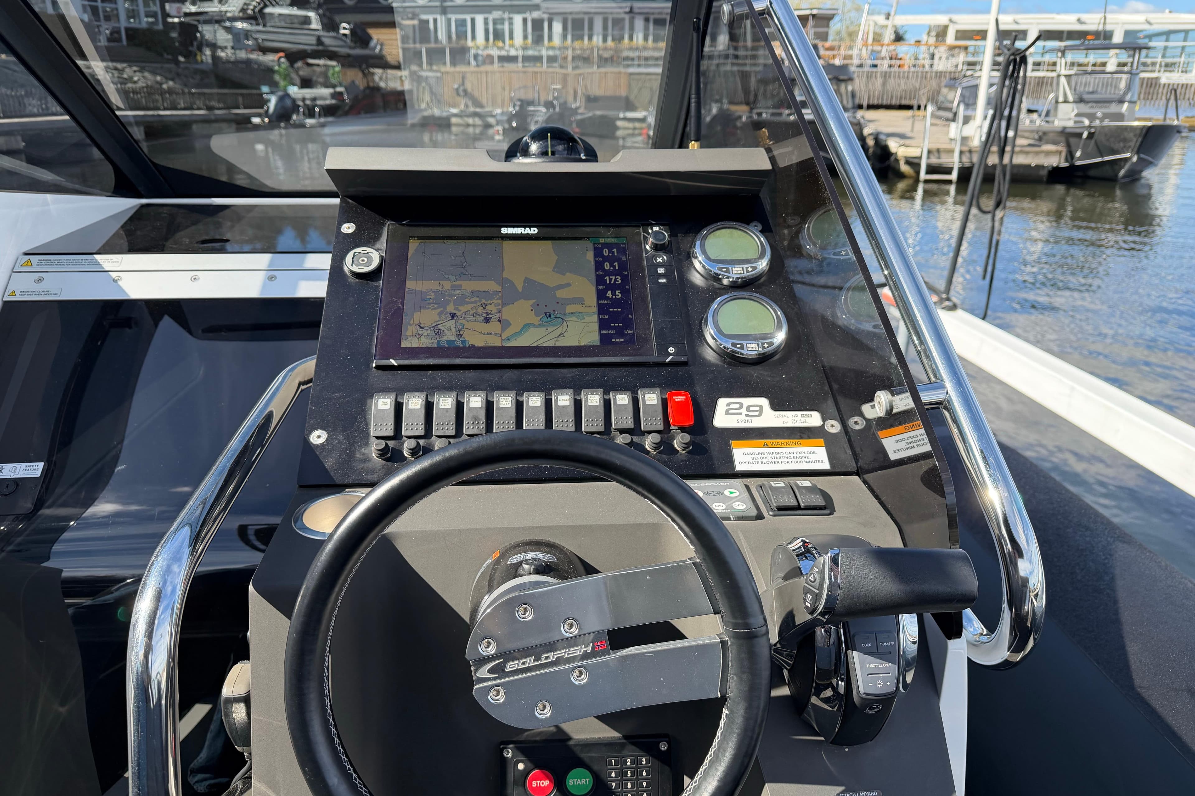 Cockpit of 2016 Goldfish 29 Sport boat with navigation controls and display.