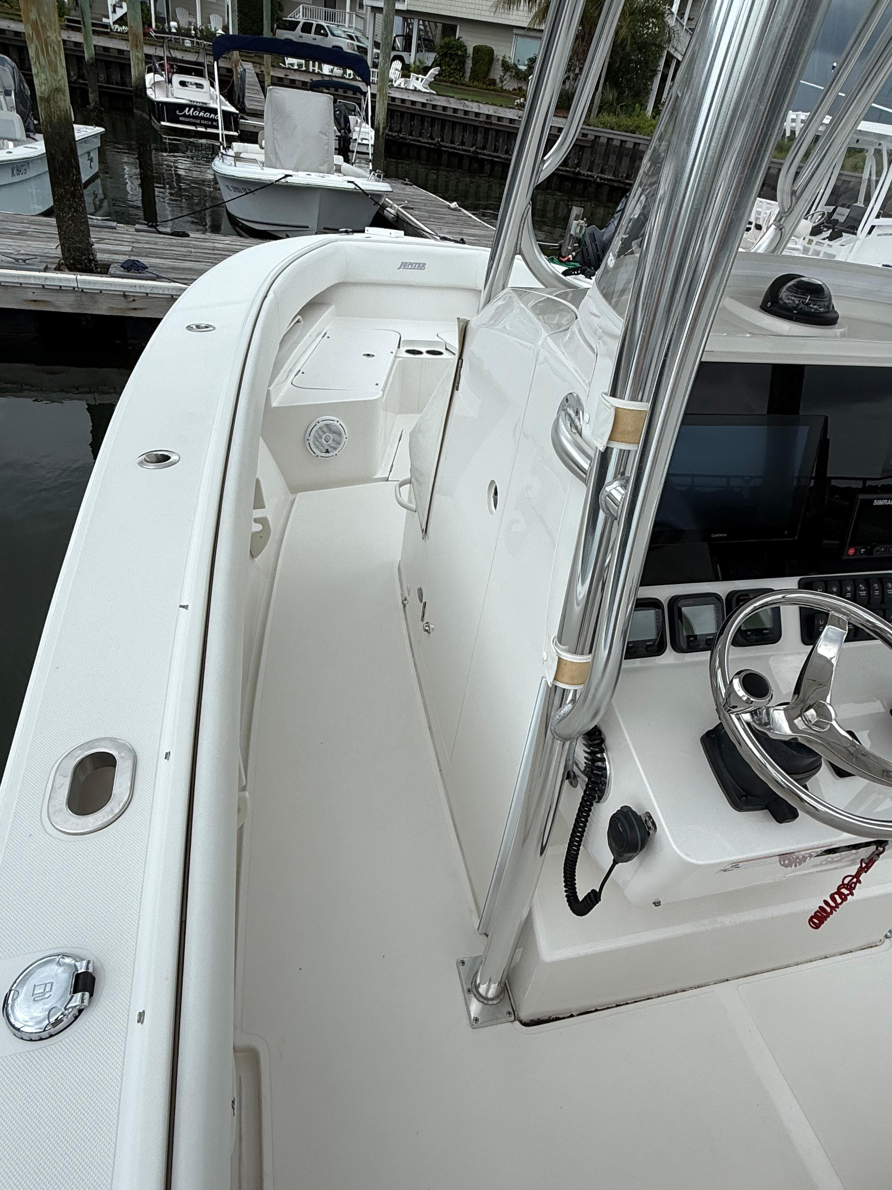 2012 Jupiter 26 boat interior with steering wheel and console, docked at marina.