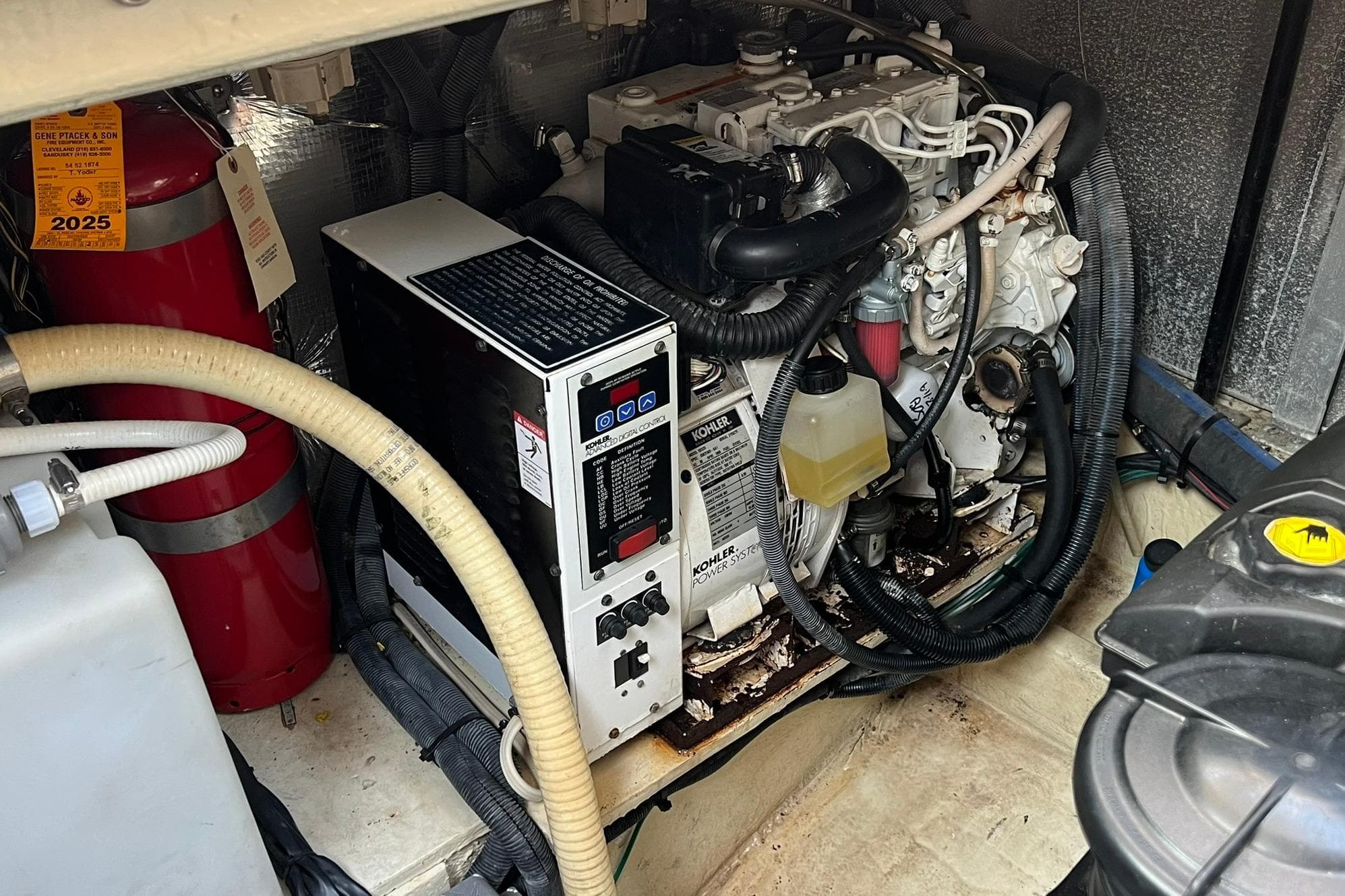 Engine room of 2008 Four Winns 378 Vista with Kohler generator and fire extinguisher.