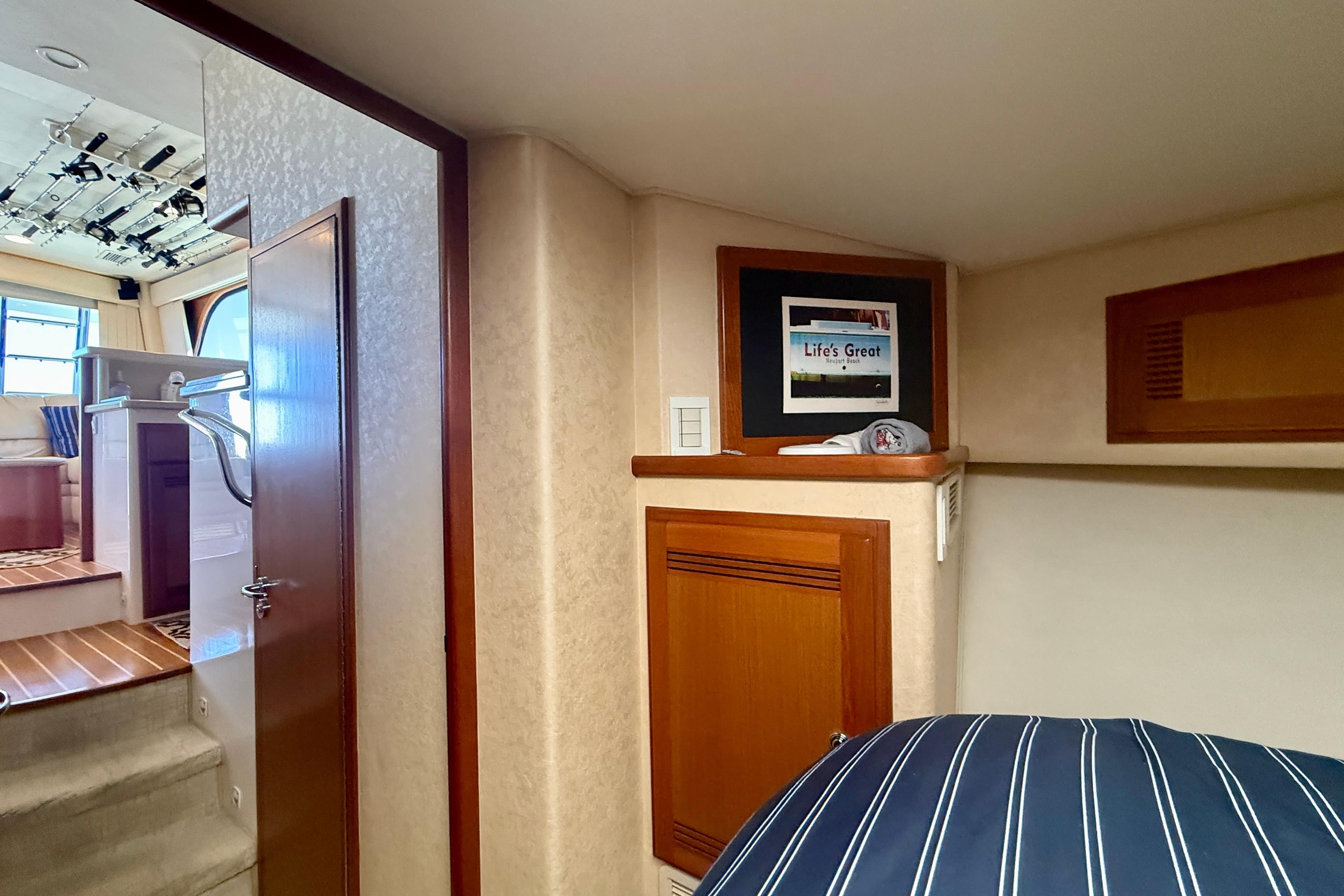 Interior of 2006 Cabo 40 Flybridge yacht with cozy cabin and framed decor.
