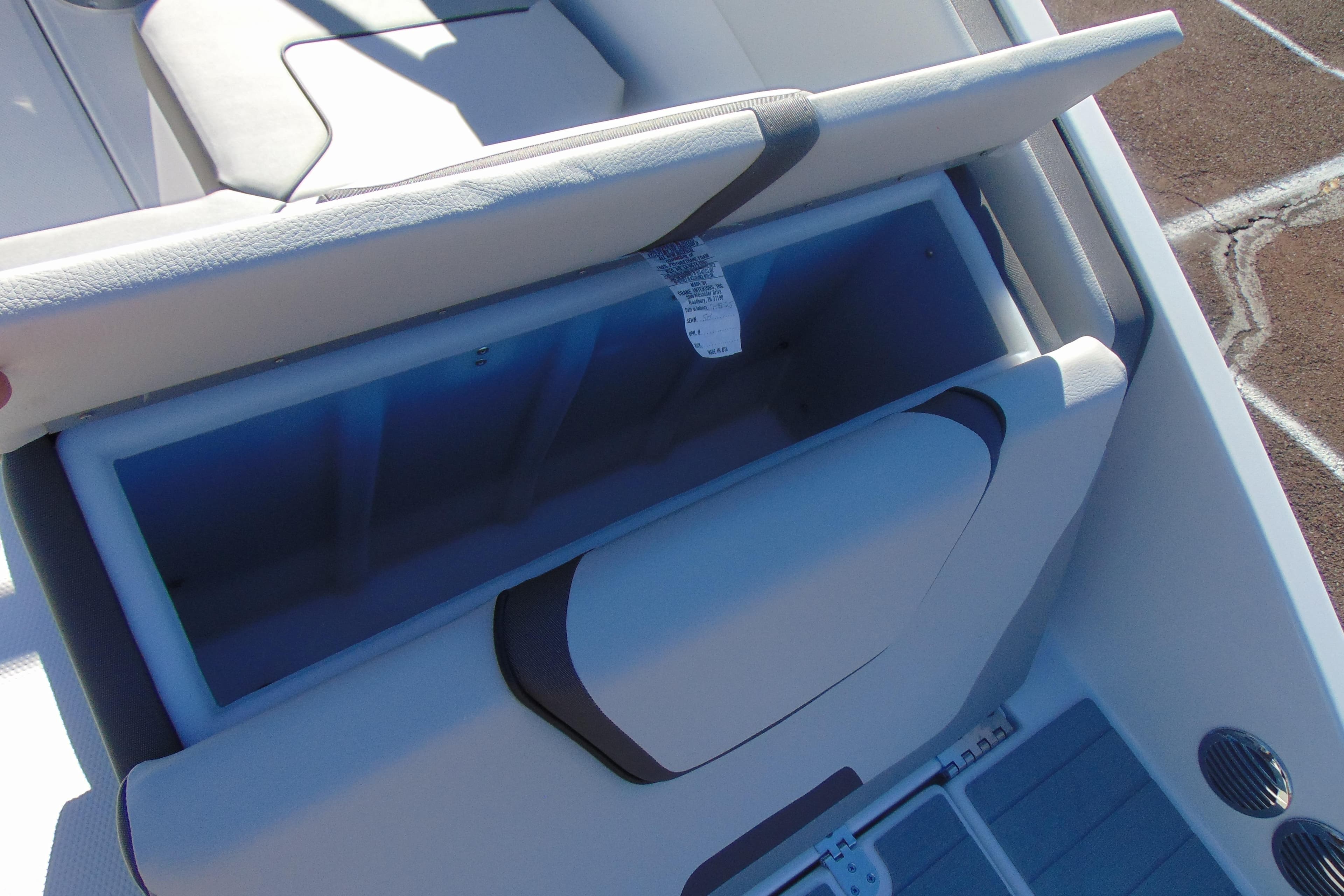 2026 Yamaha Boats AR220 storage compartment with open seat, showcasing interior space.