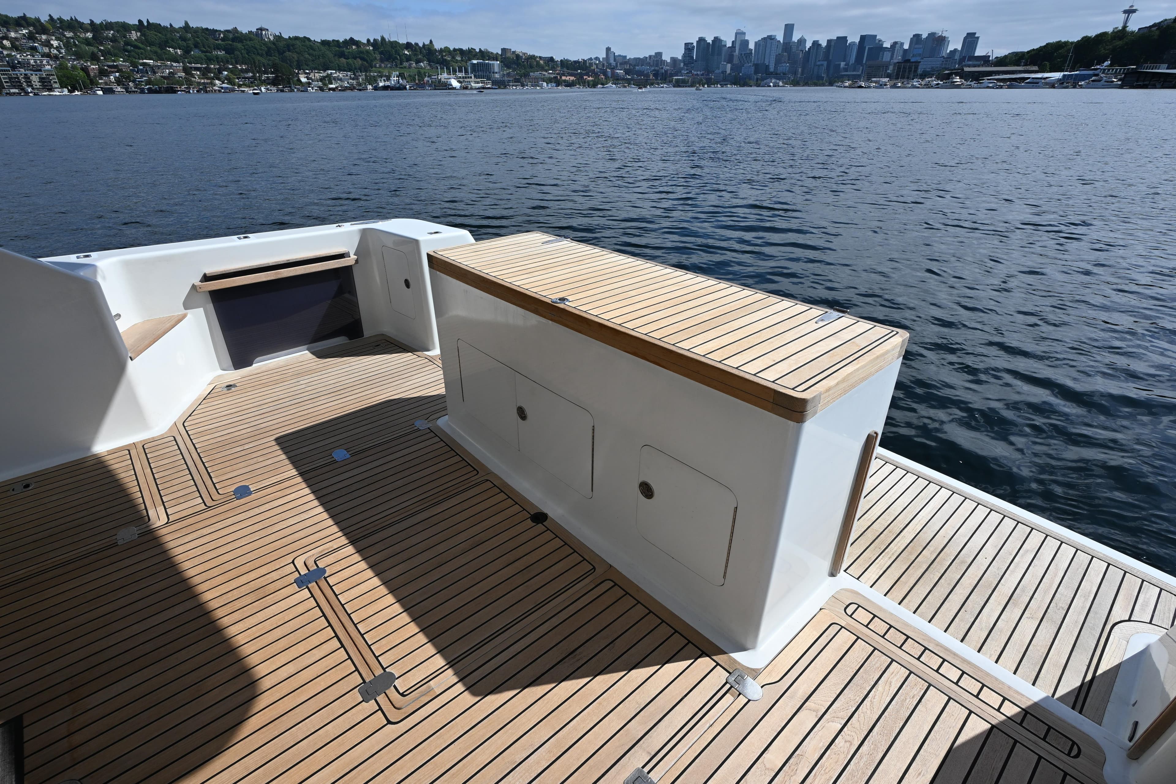 Deck view of 2002 Roger Hill Power Cat 41.4, overlooking water and city skyline.
