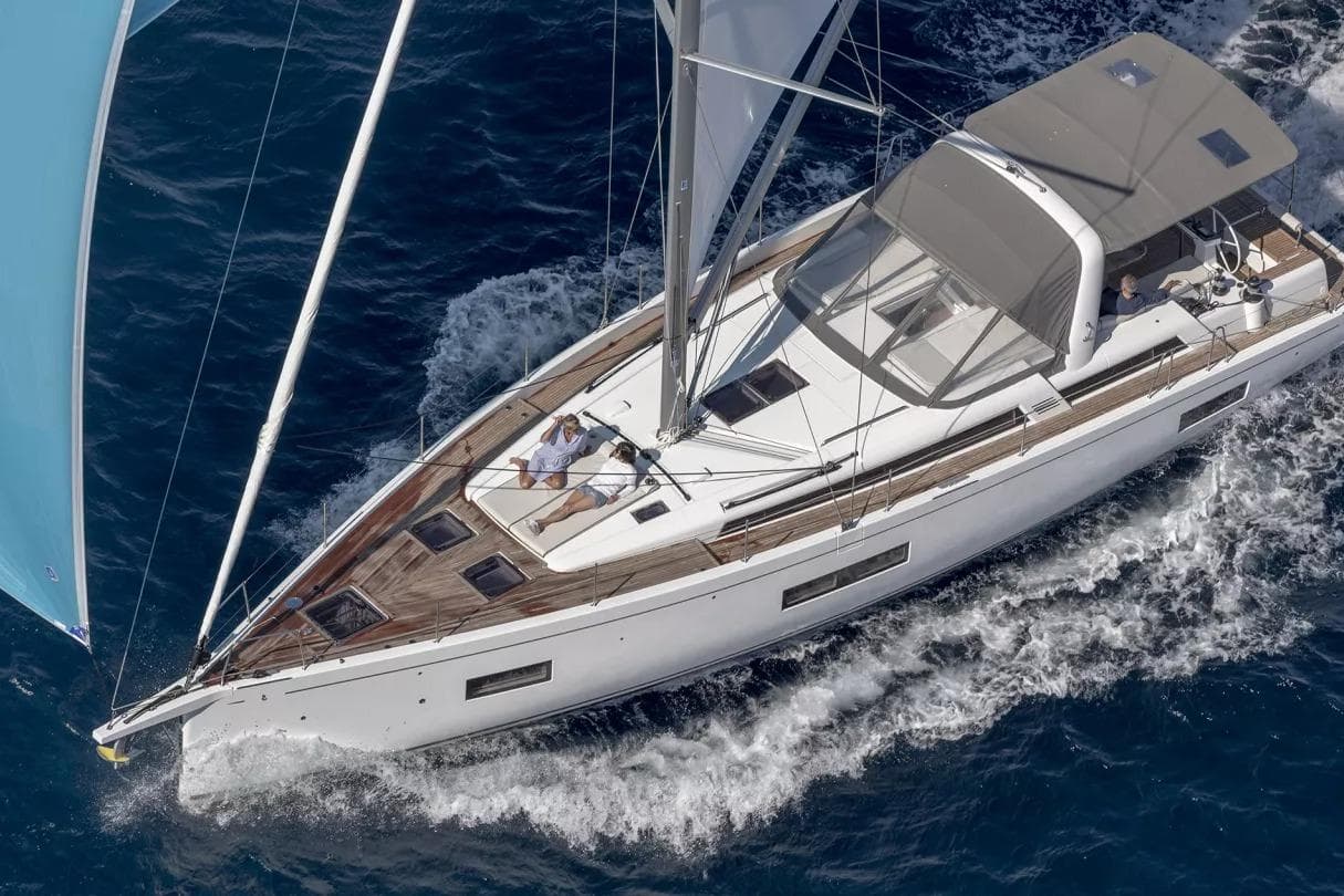 2026 Beneteau Oceanis Yacht 54 sailing on open sea, aerial view.