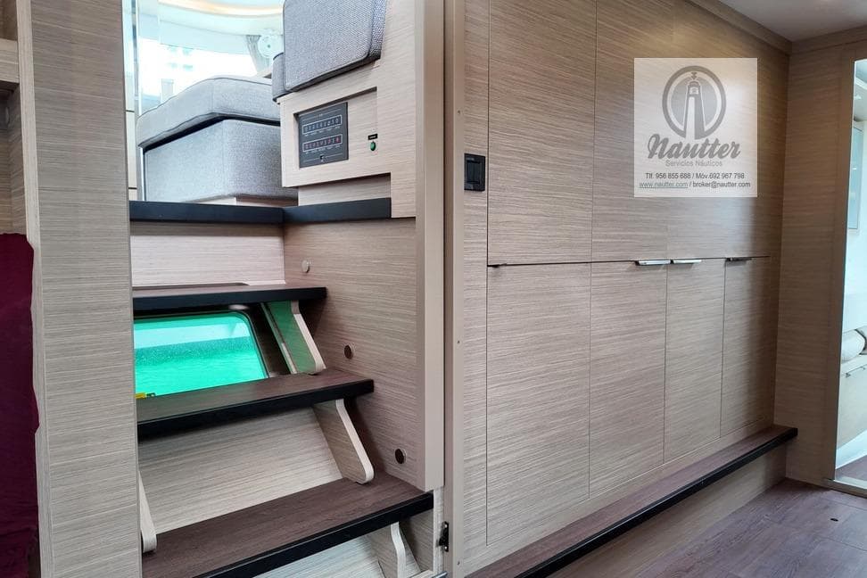 Interior of 2023 Lagoon 46 yacht with modern wooden stairs and seating area.