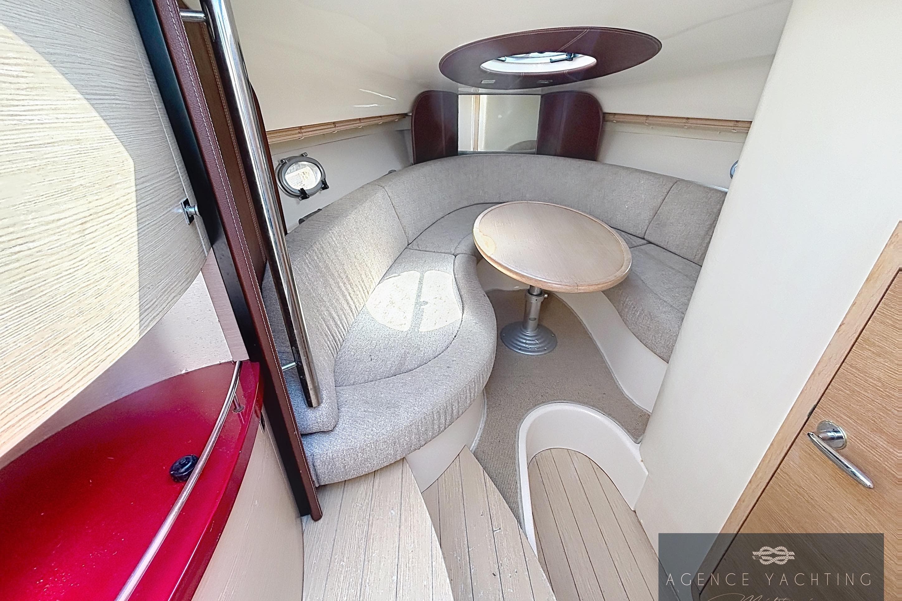 Interior of 2007 Sessa Marine S32 yacht with cozy seating and round table.