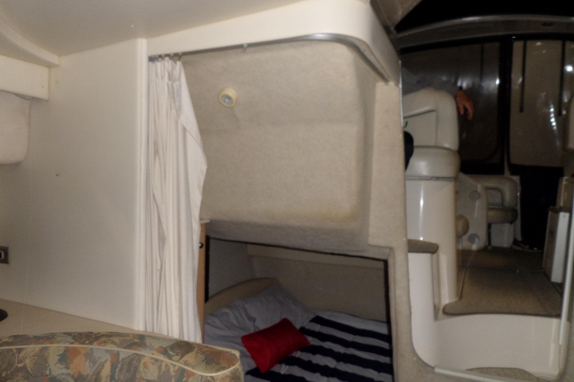 Interior cabin of a 2000 Bayliner 3055 Ciera boat with bed and seating area.