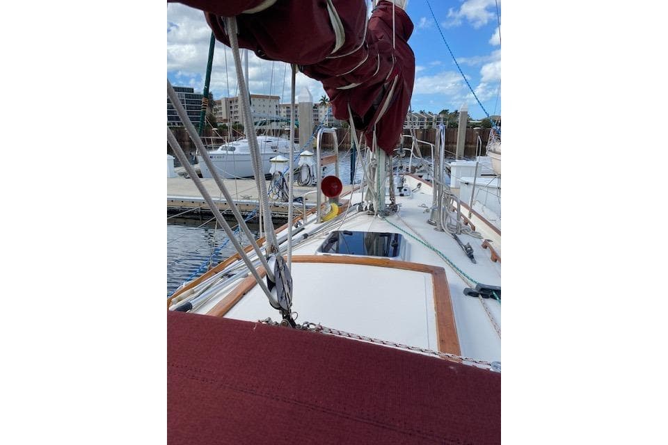 Sailboat deck view of 1995 Pacific Seacraft Crealock 34 at marina, clear sky.