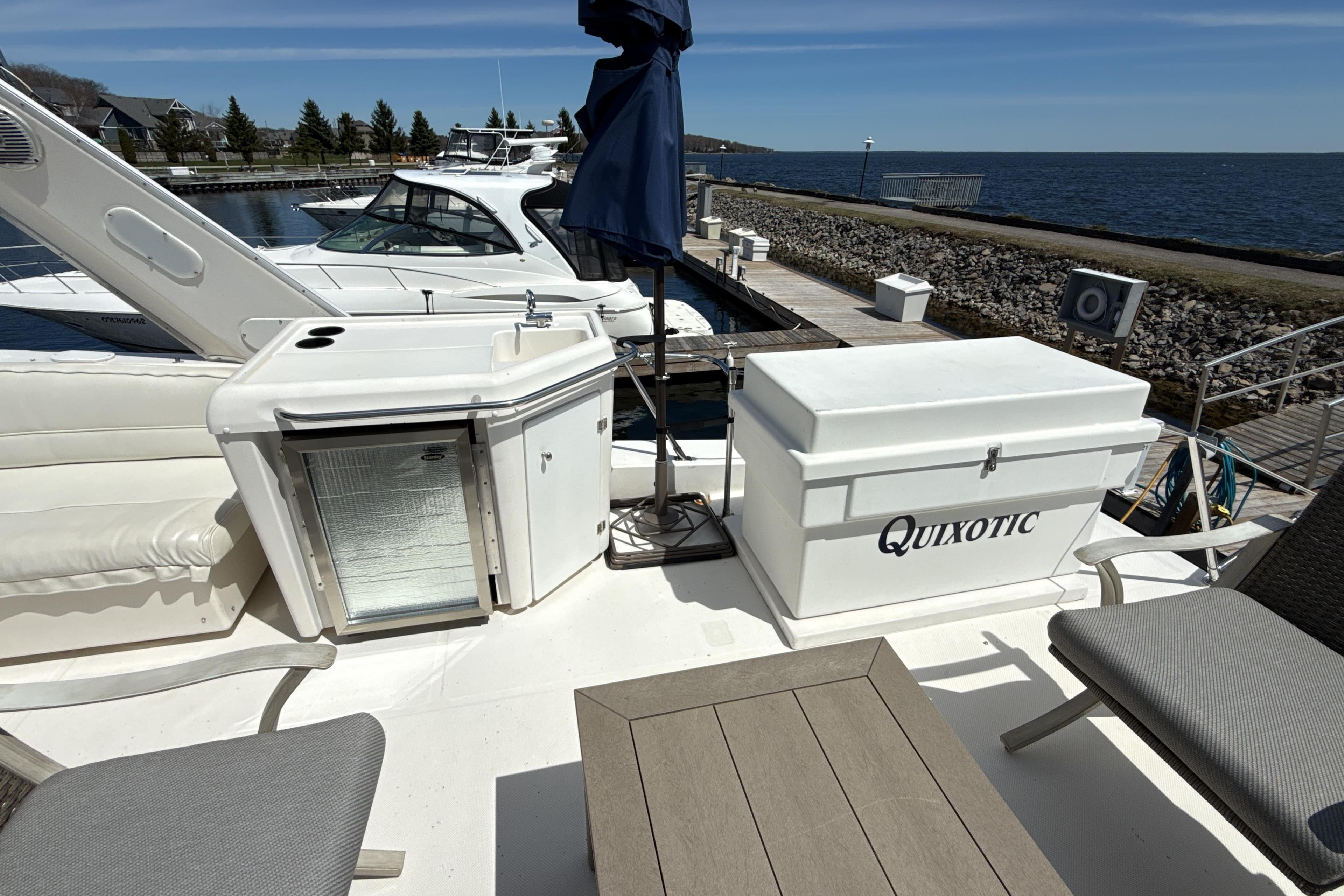 1997 Bayliner 4788 Pilot House Motoryacht deck with seating, cooler, and ocean view.