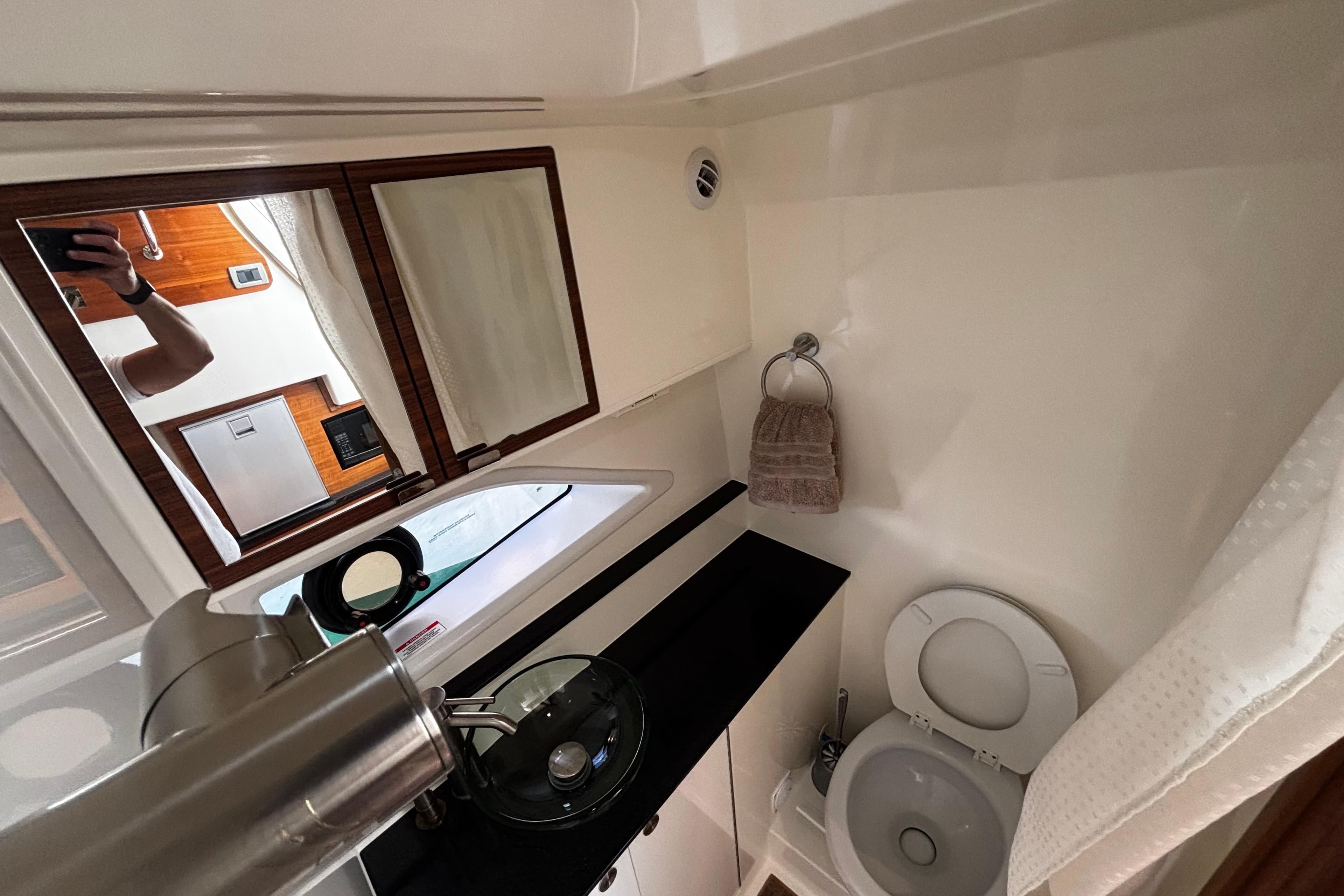 Bathroom interior of 2022 Sea Ray Sundancer 320 yacht, featuring modern fixtures and compact design.