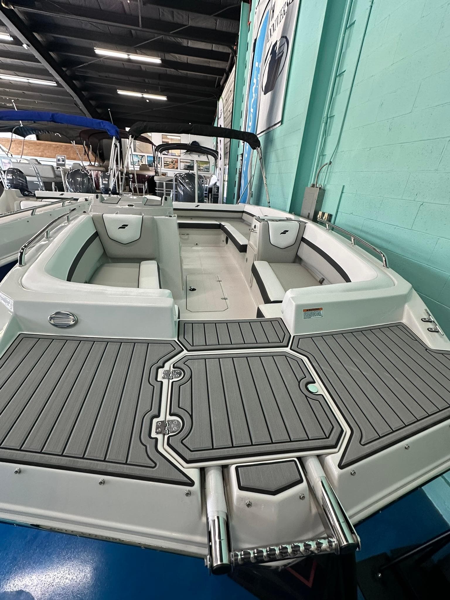 2025 Starcraft SVX 211 OB boat with spacious seating and modern design in showroom.