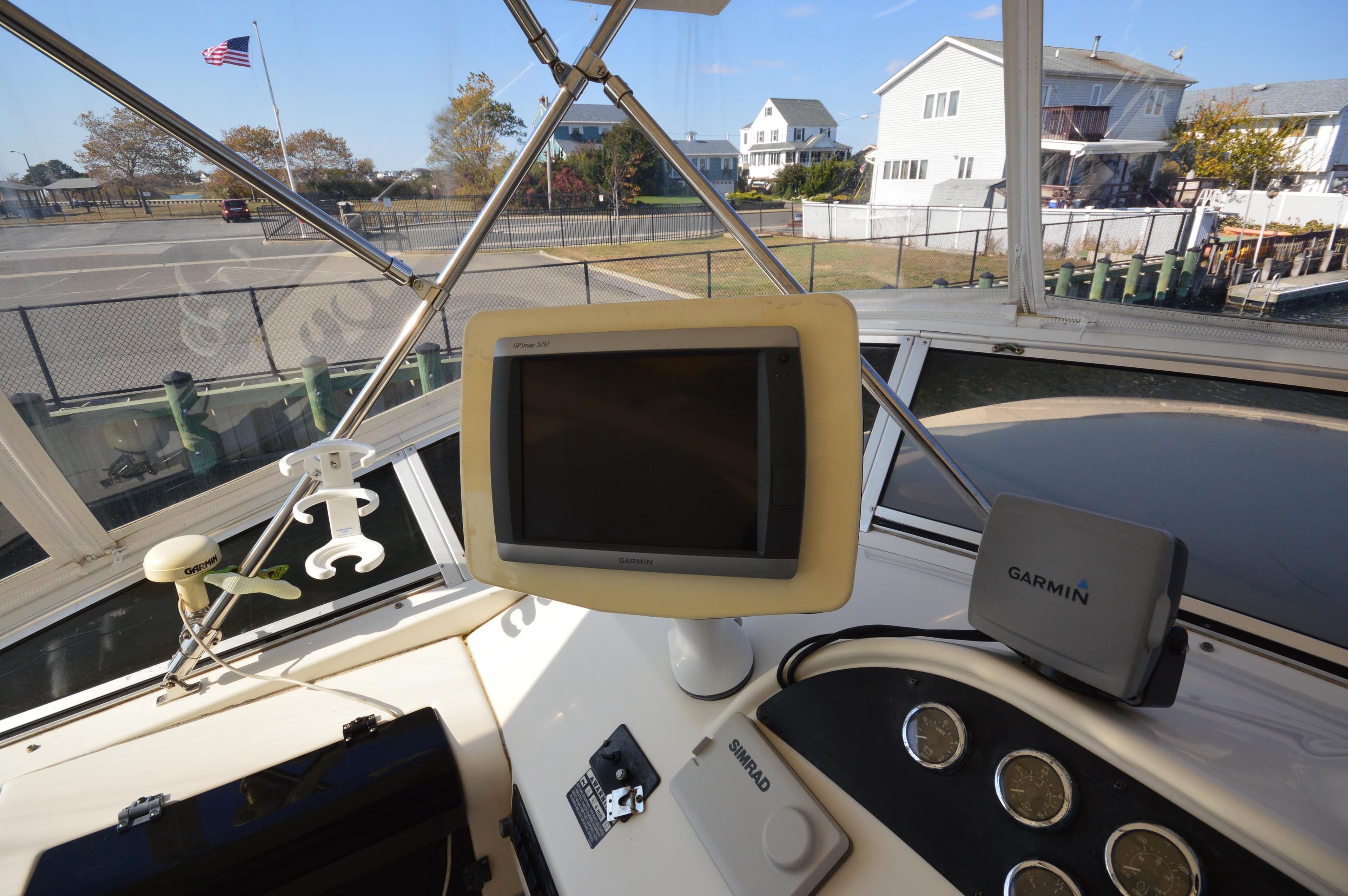 2007 Meridian 490 Pilothouse helm with Garmin navigation system and waterfront view.