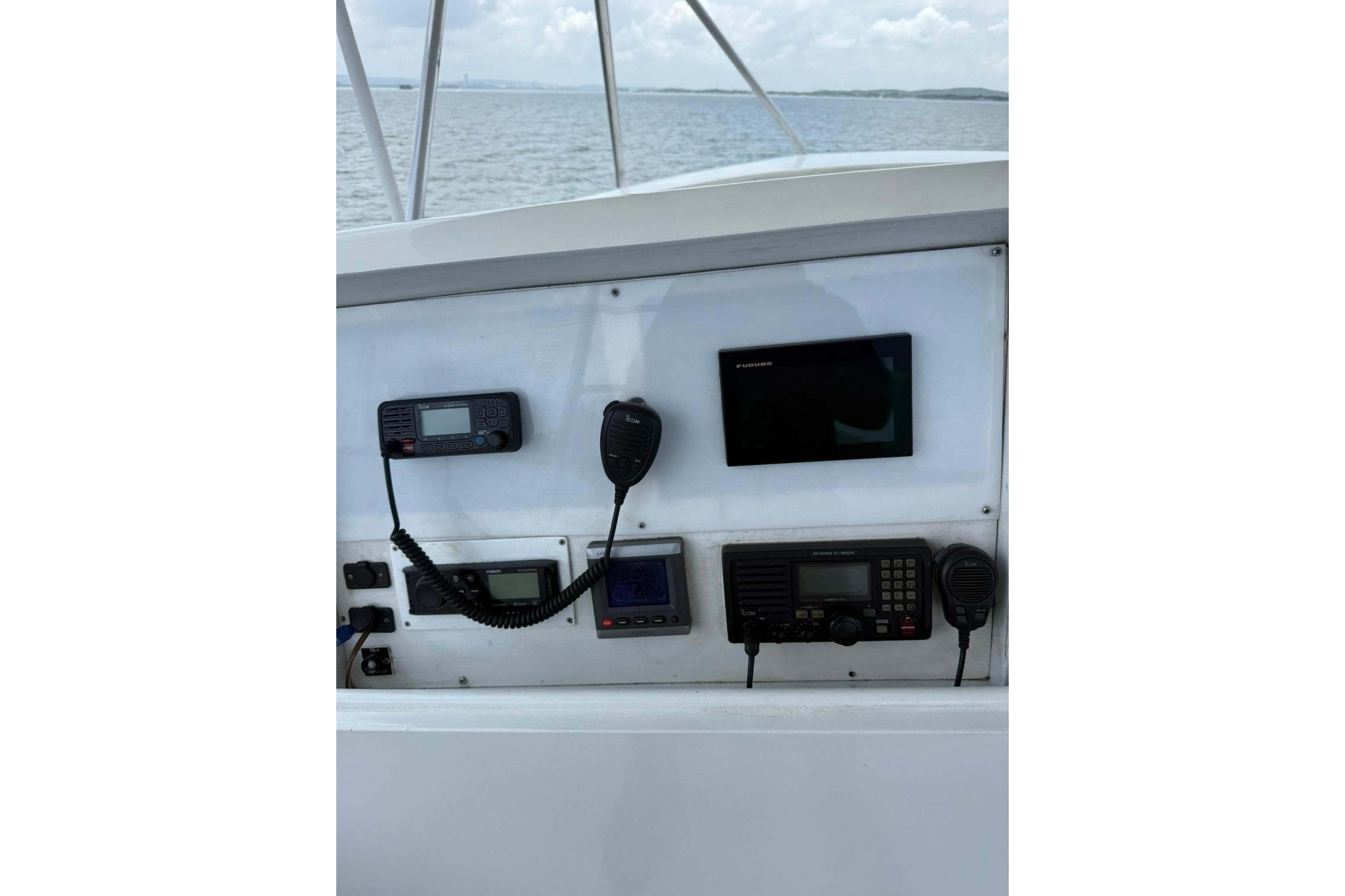 Control panel of a 1989 Buddy Davis 61 boat with navigation and communication equipment.