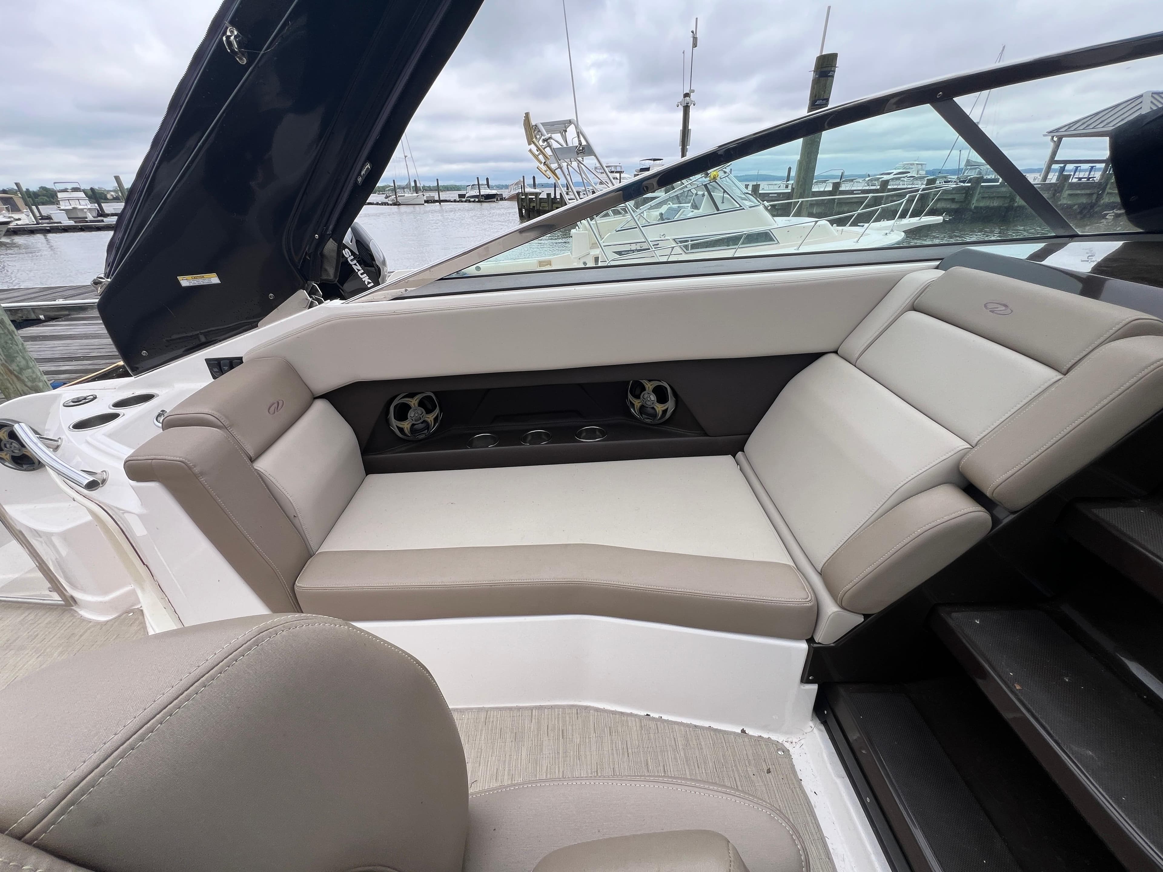 2015 Regal 28 Express boat interior with beige seating at a marina.