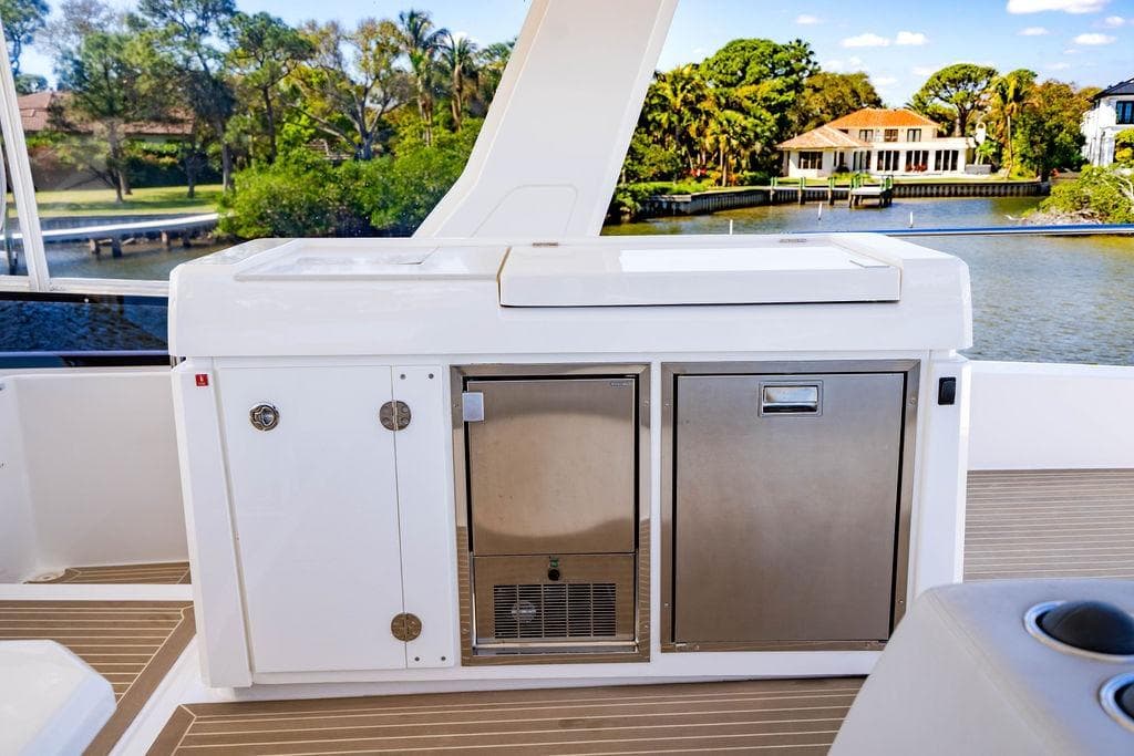 Outdoor kitchen on 2022 Leopard 53 Powercat yacht with scenic waterfront view.