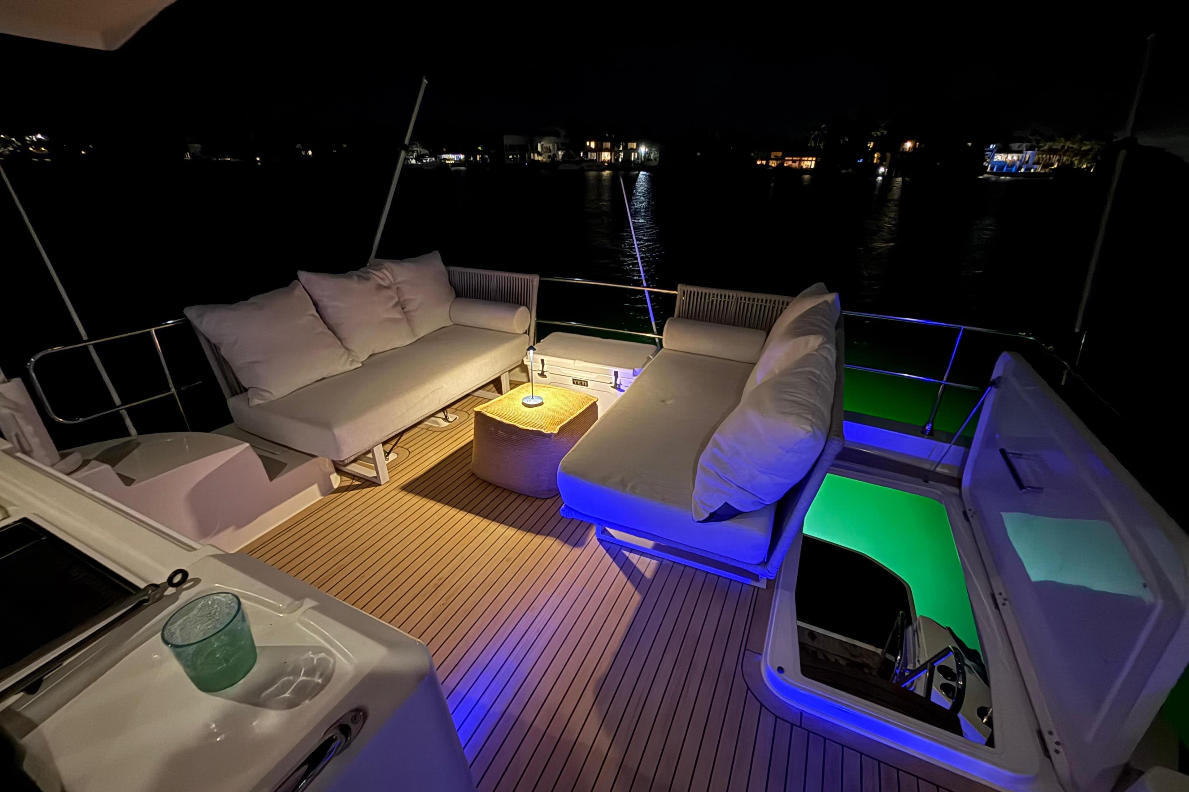 Luxurious 2019 Beneteau Swift Trawler 47 deck at night with ambient lighting.