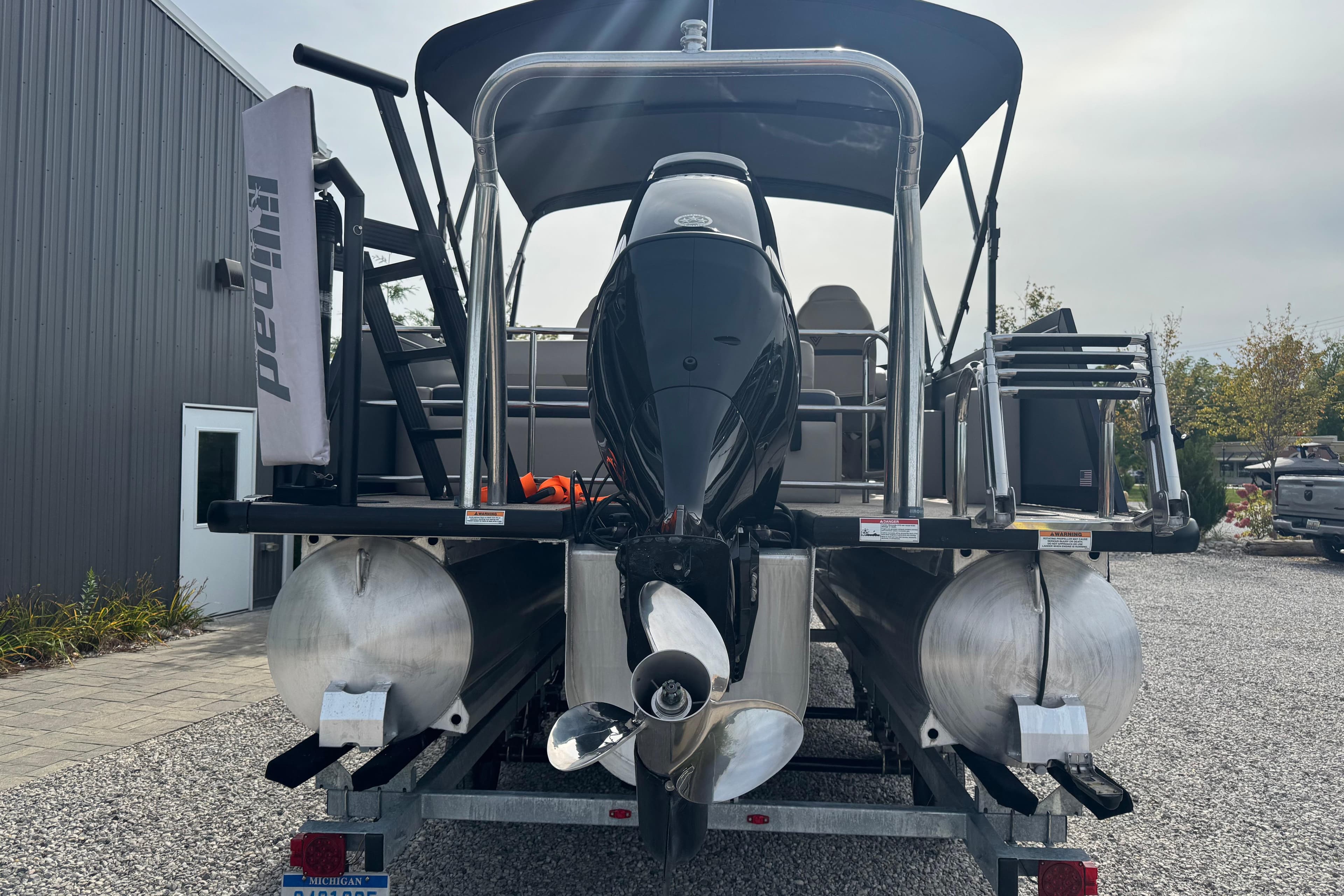 2023 Viaggio DIAMANTE 23S pontoon boat with outboard motor on trailer.