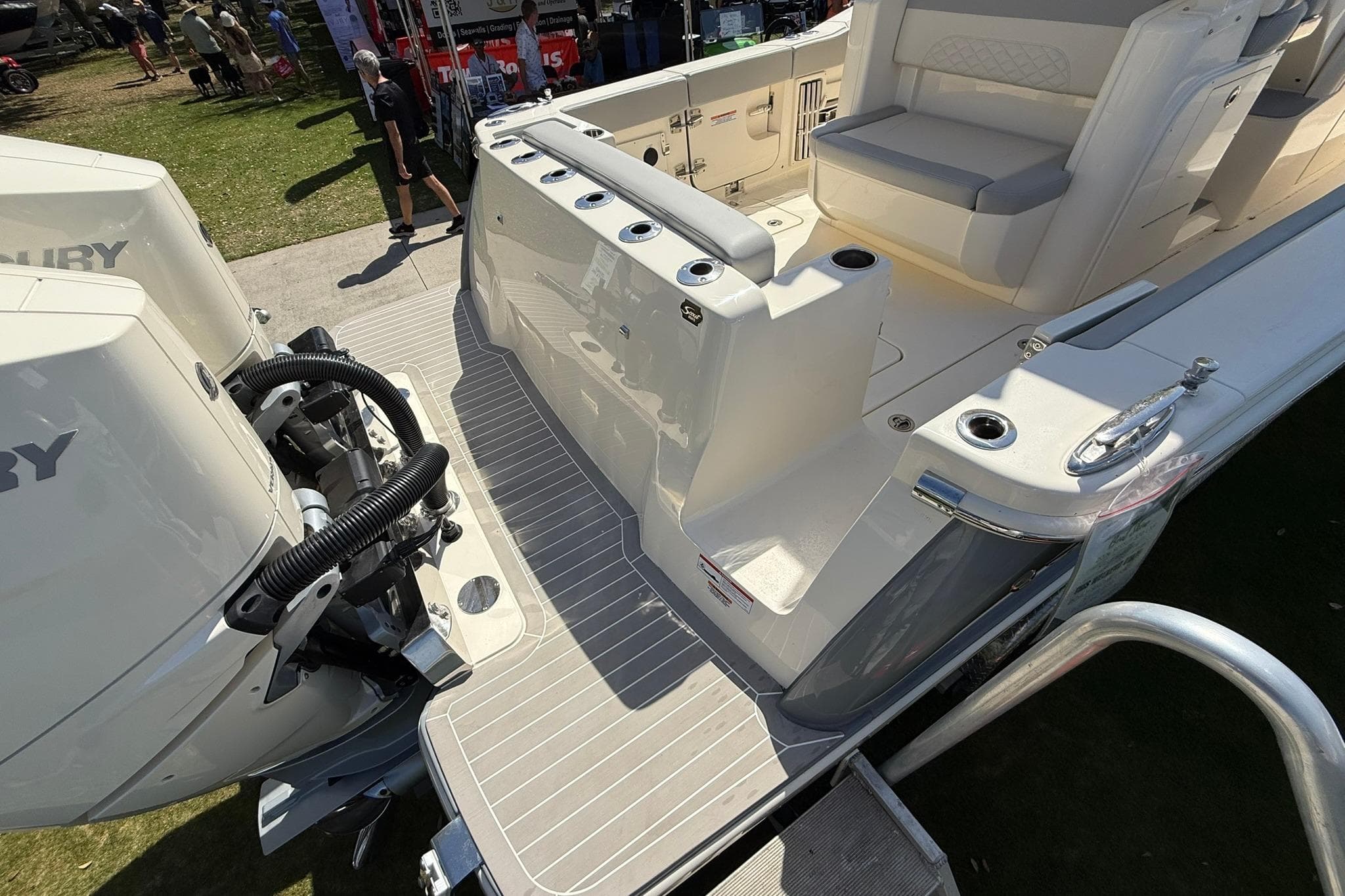 2026 Scout 330 LXF boat with Mercury engines, featuring spacious deck and seating area.