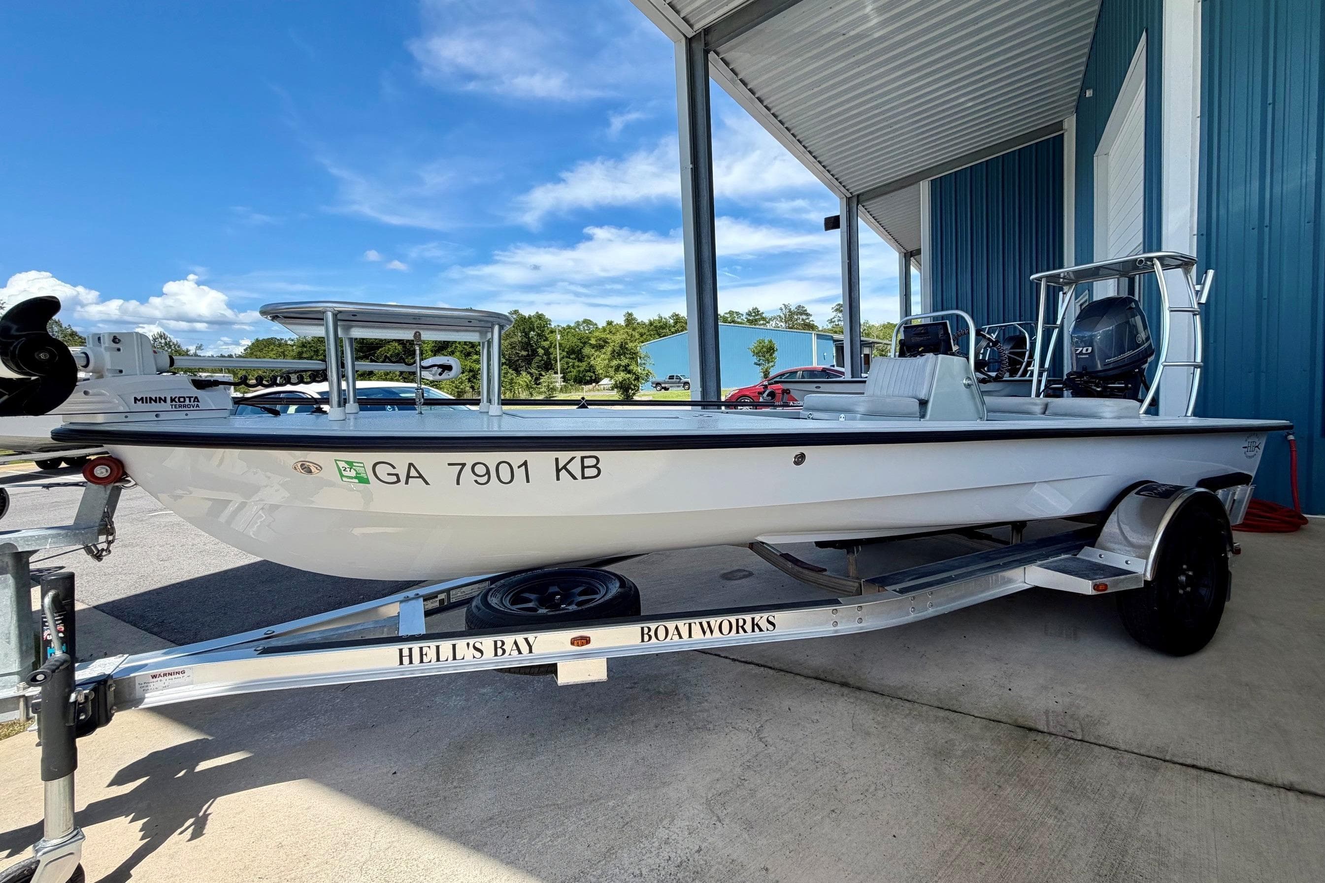 2020 Hells Bay Professional boat on trailer, parked under a metal canopy.