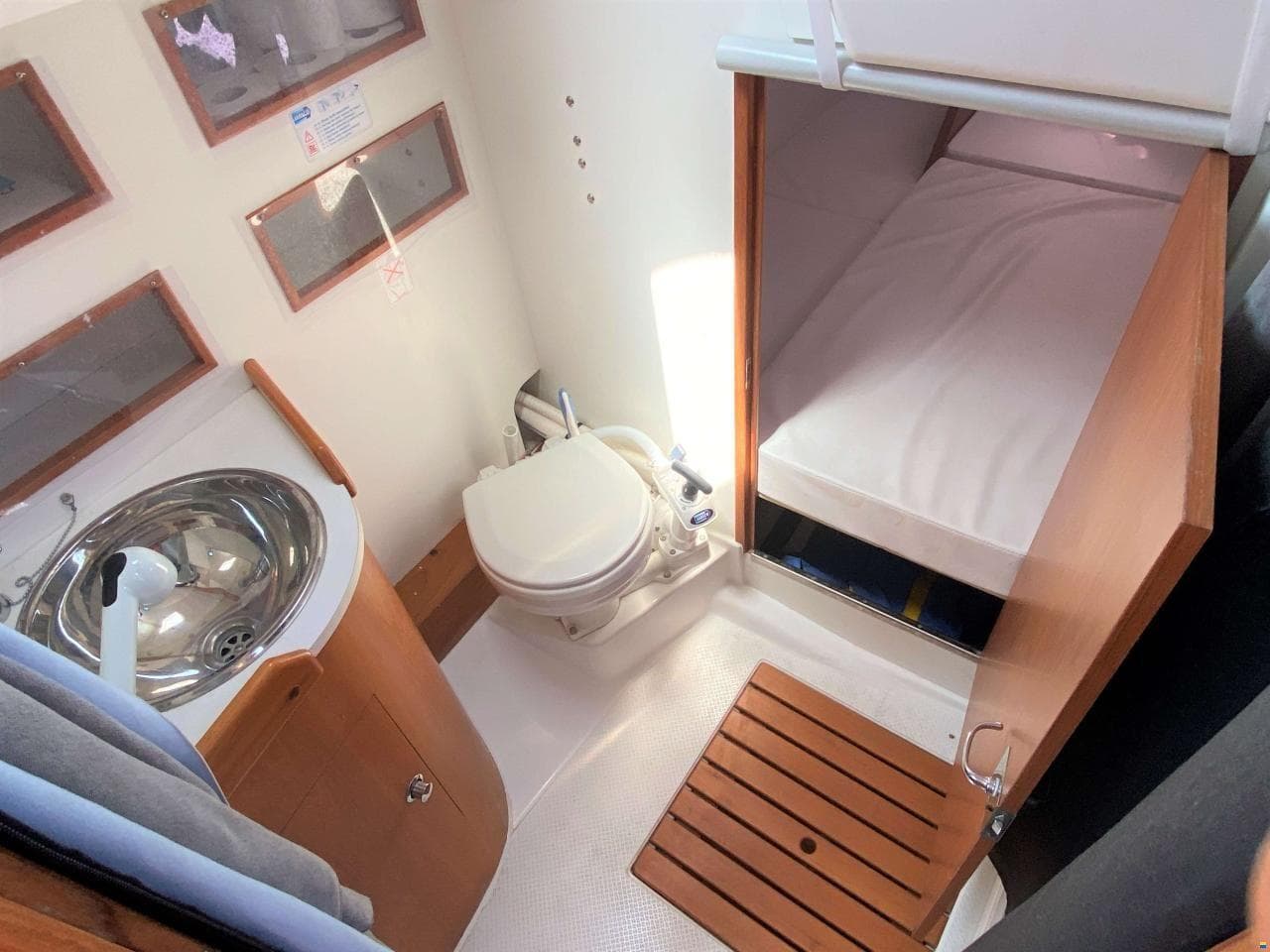 Interior of 2003 Wauquiez Opium 39 yacht showing bathroom and compact sleeping area.