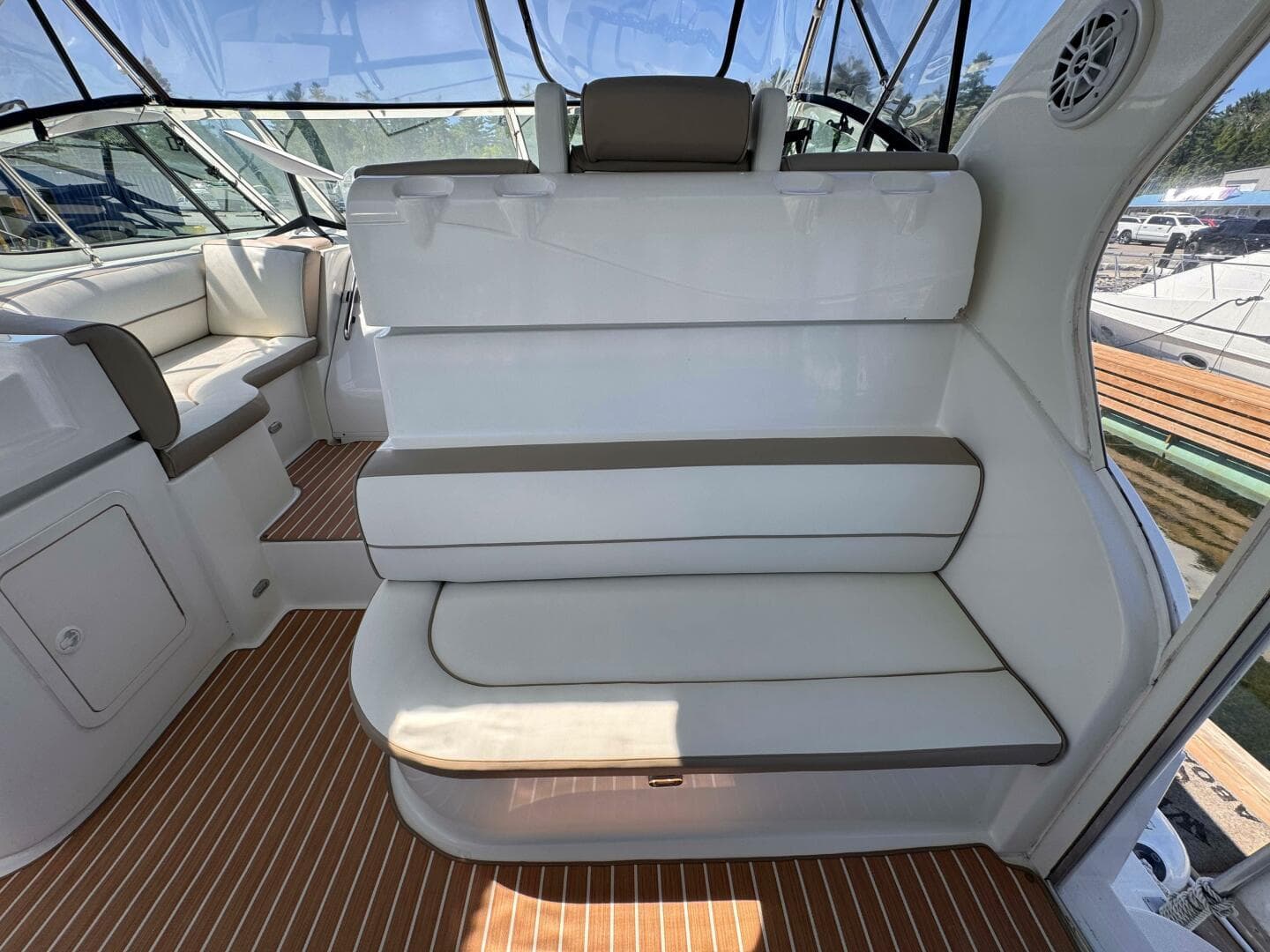 2002 Cruisers Yachts 4450 Express Motor Yacht interior with white seating and wood flooring.