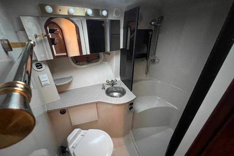 Luxurious bathroom in 2004 Four Winns 378 Vista yacht, featuring modern fixtures and elegant design.