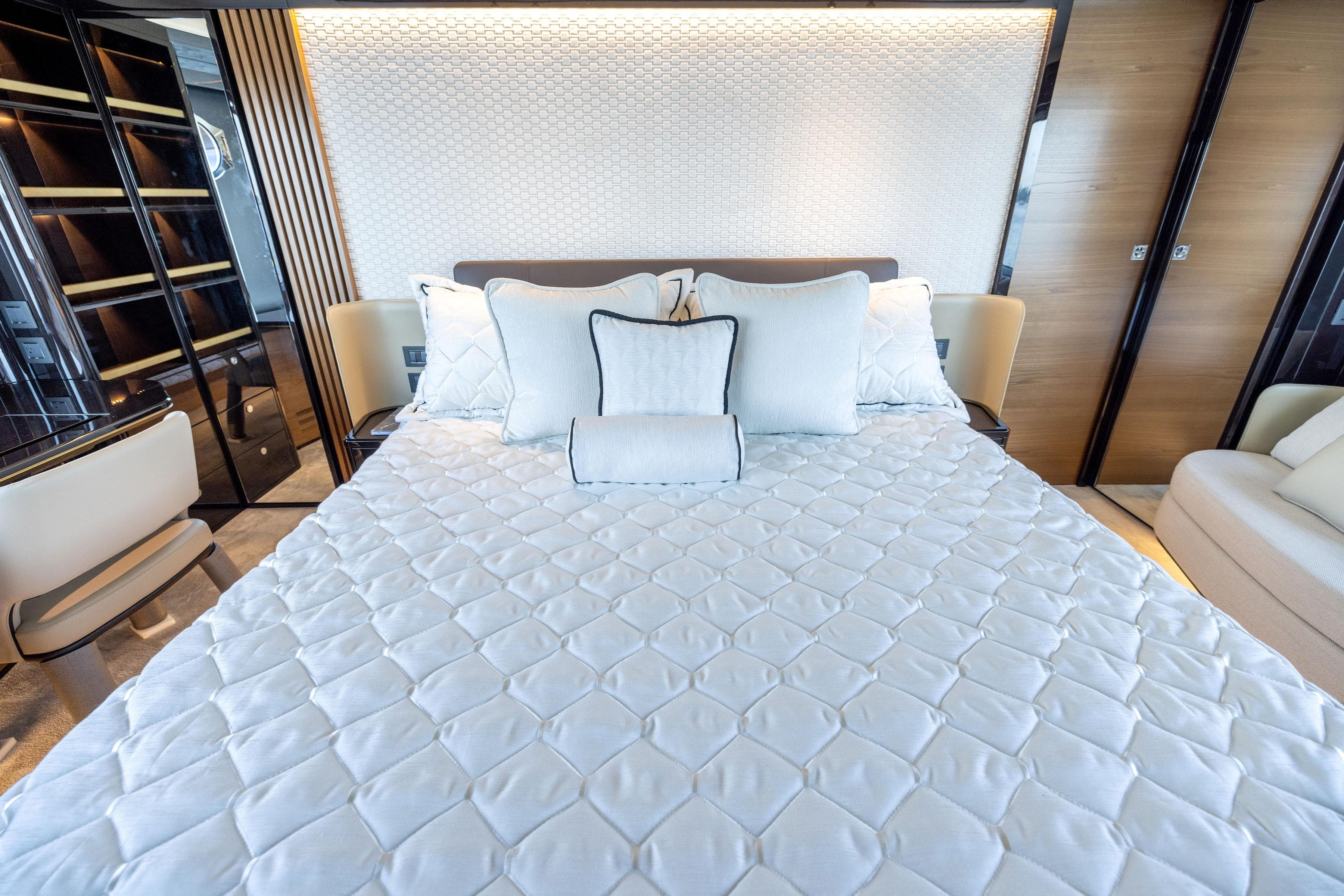 Luxurious bedroom interior of 2024 Absolute Navetta 64 yacht with elegant bedding and modern design.