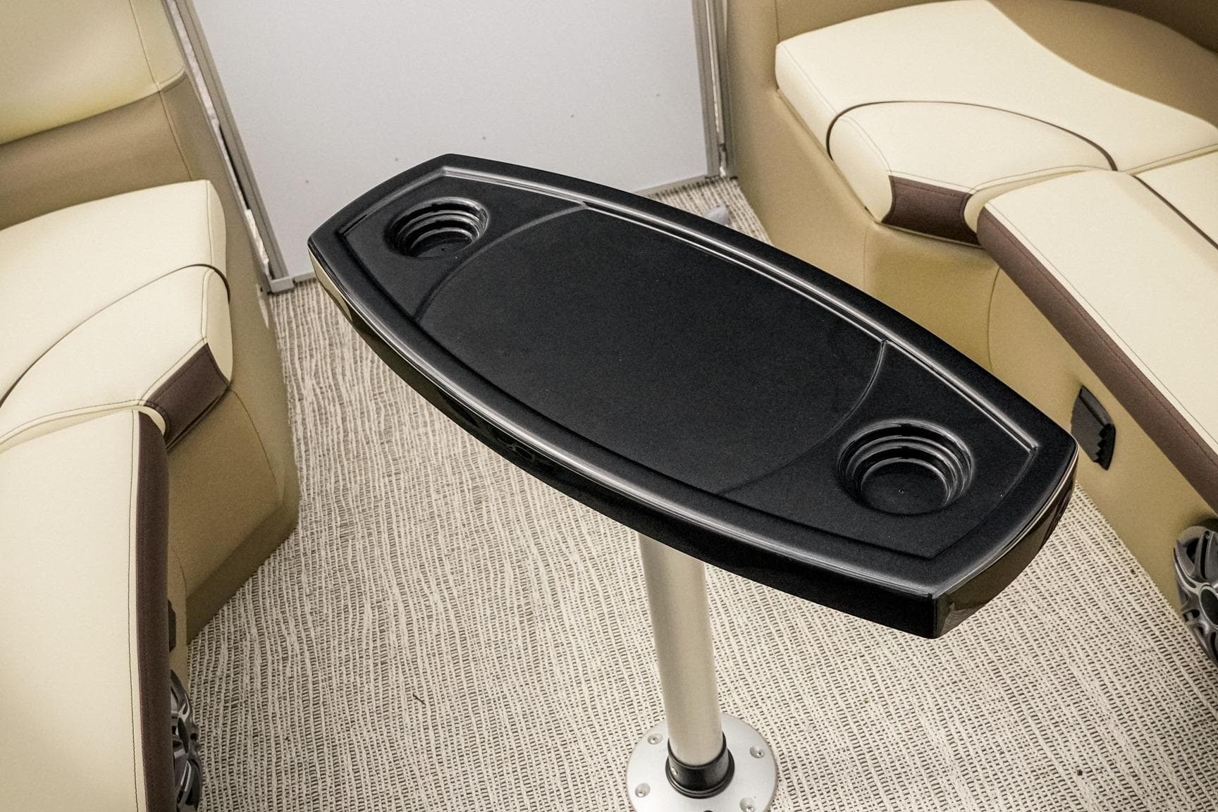 Interior of 2026 SunCatcher Select 22RC boat with table and cup holders.