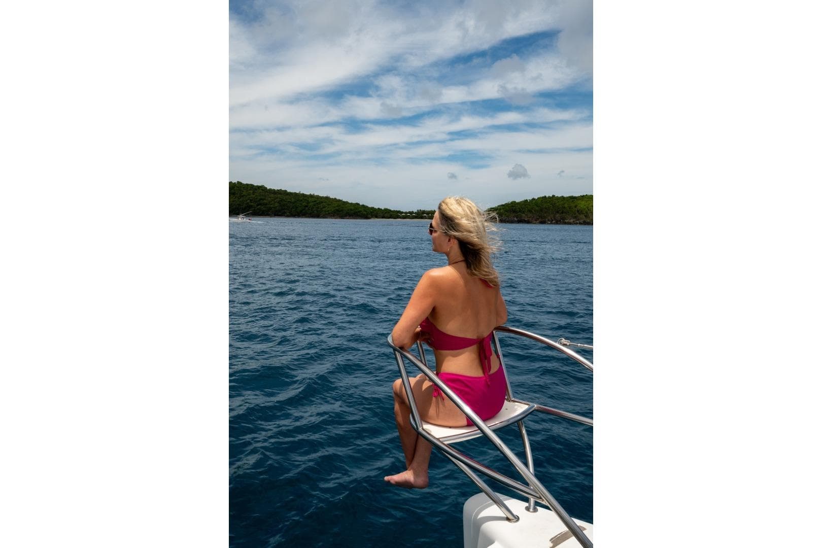 Woman in pink swimsuit on 2013 Fountaine Pajot Sanya 57, enjoying ocean view.