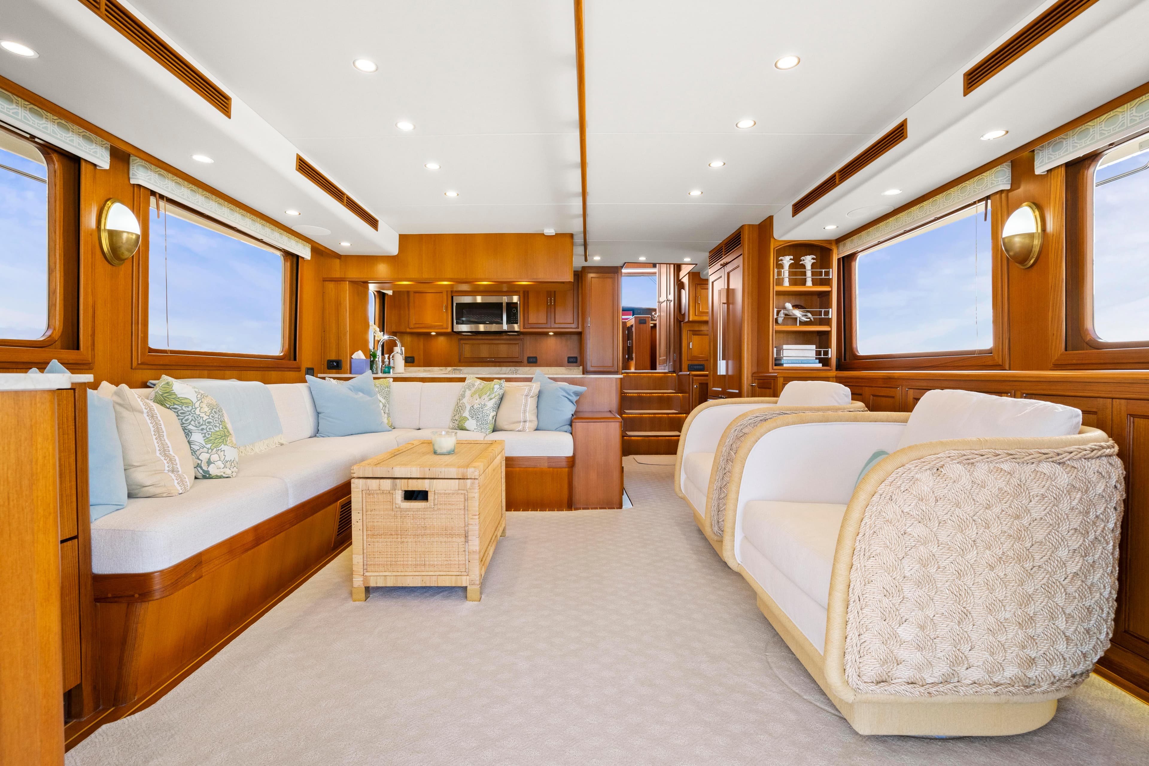 Luxurious interior of 2023 Fleming 65 yacht with elegant seating and wooden finishes.
