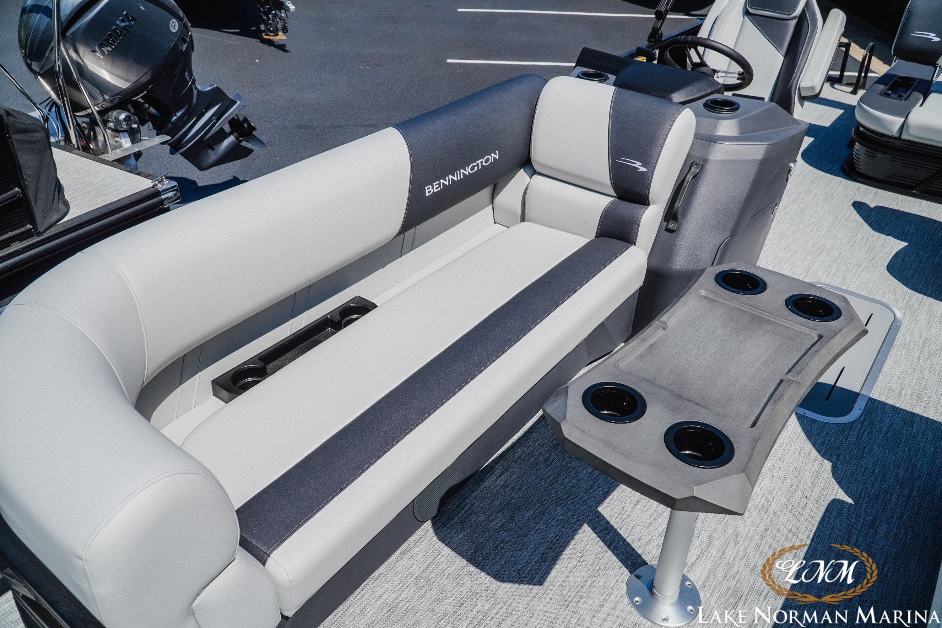 2026 Bennington 22SSB pontoon boat interior with plush seating and cup holders.