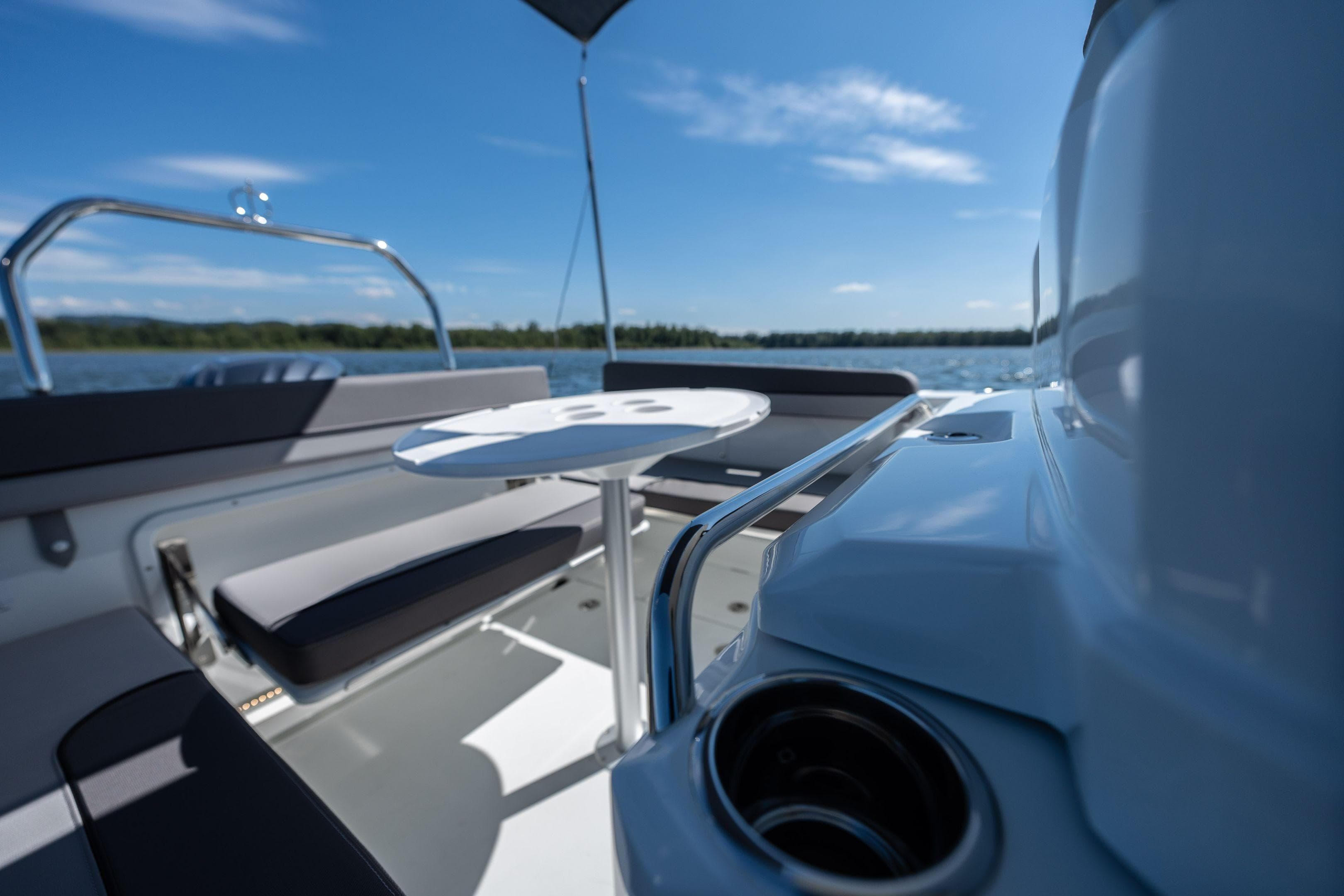 2026 Jeanneau Leader 7.5 WA Series 3 boat interior with seating and table on a sunny day.