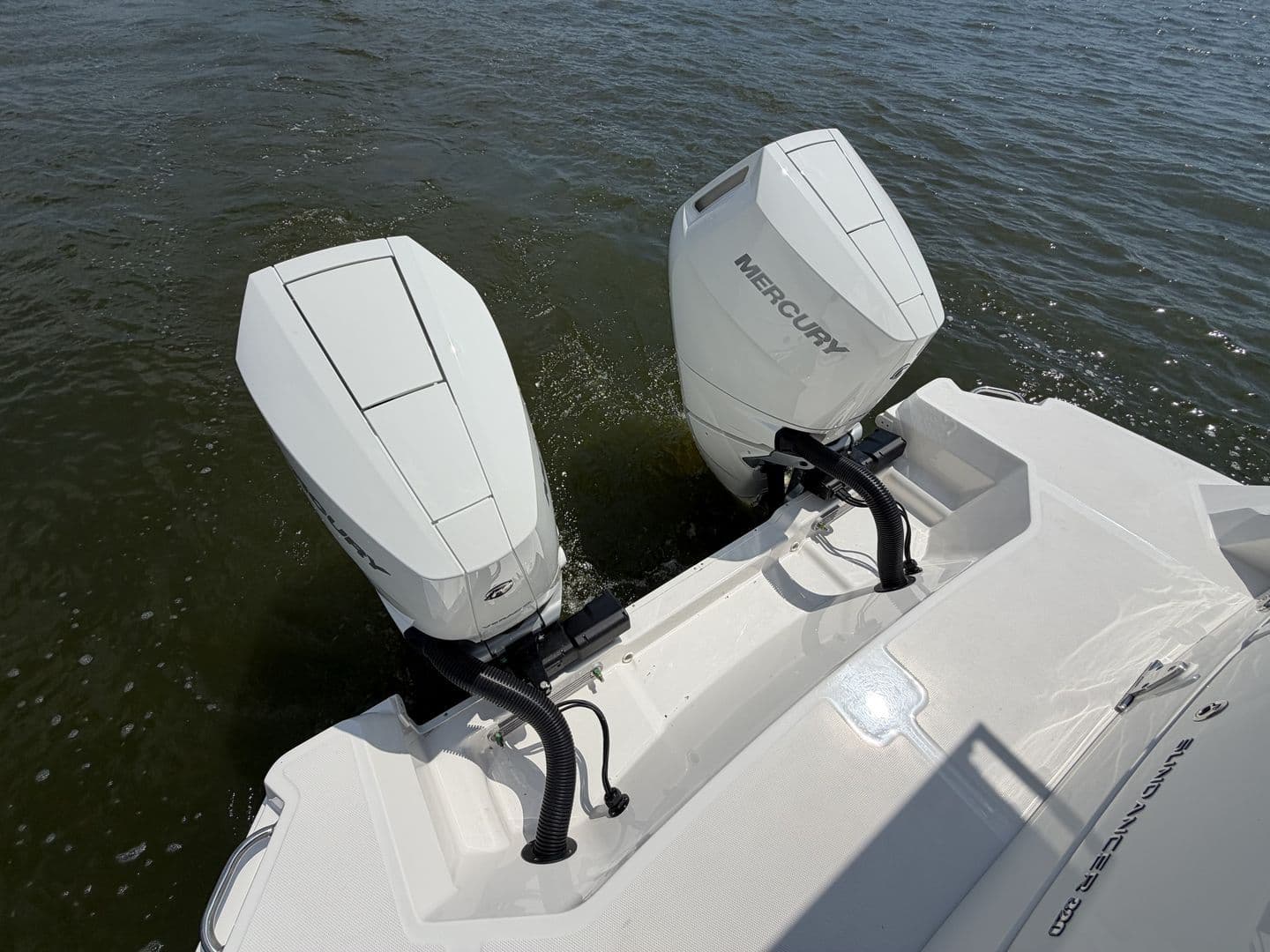 2026 Sea Ray Sundancer 320 with Mercury outboard engines on water.