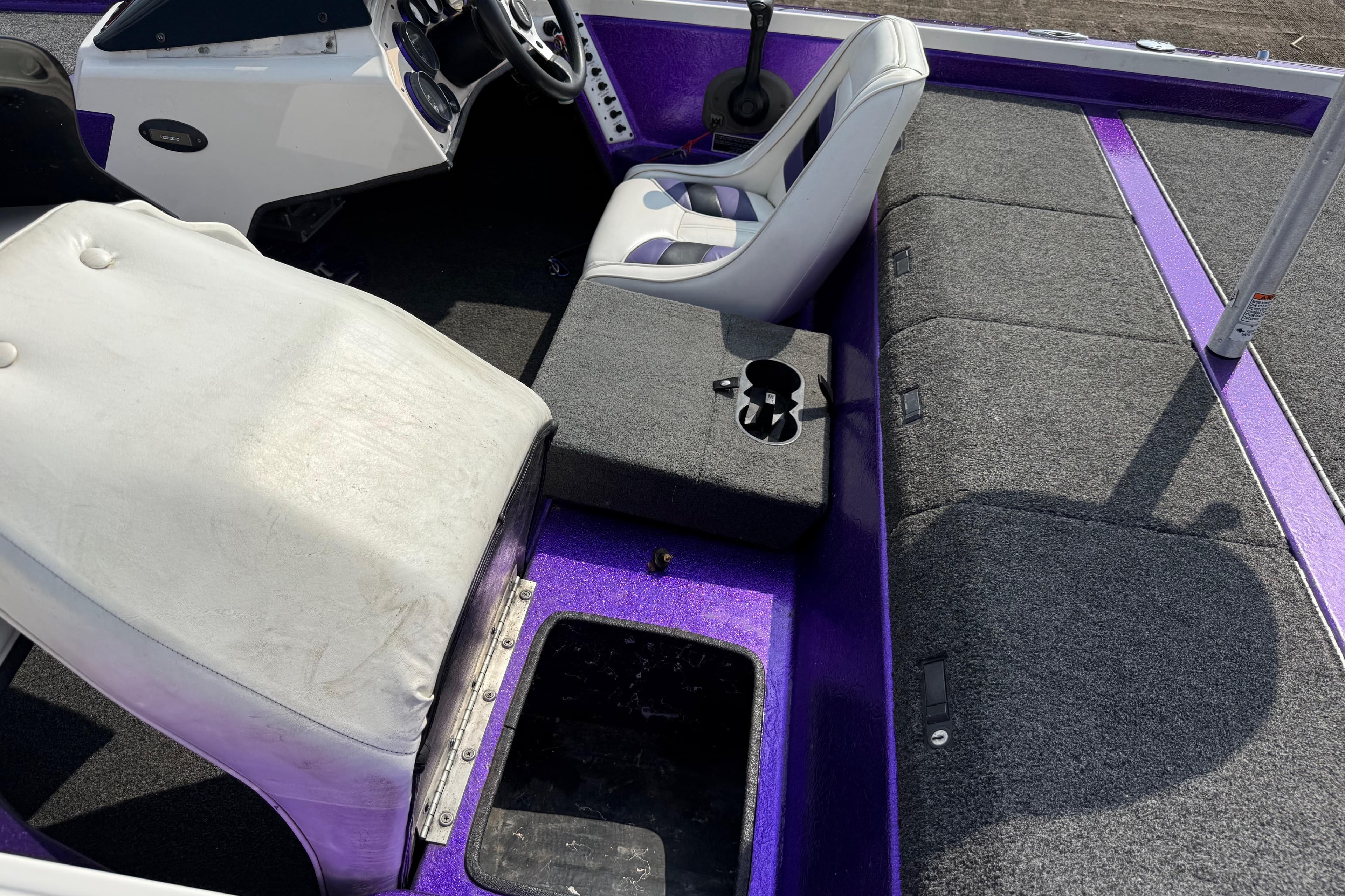 Interior of a 2002 Bullet 21XDC boat with purple accents and seating.