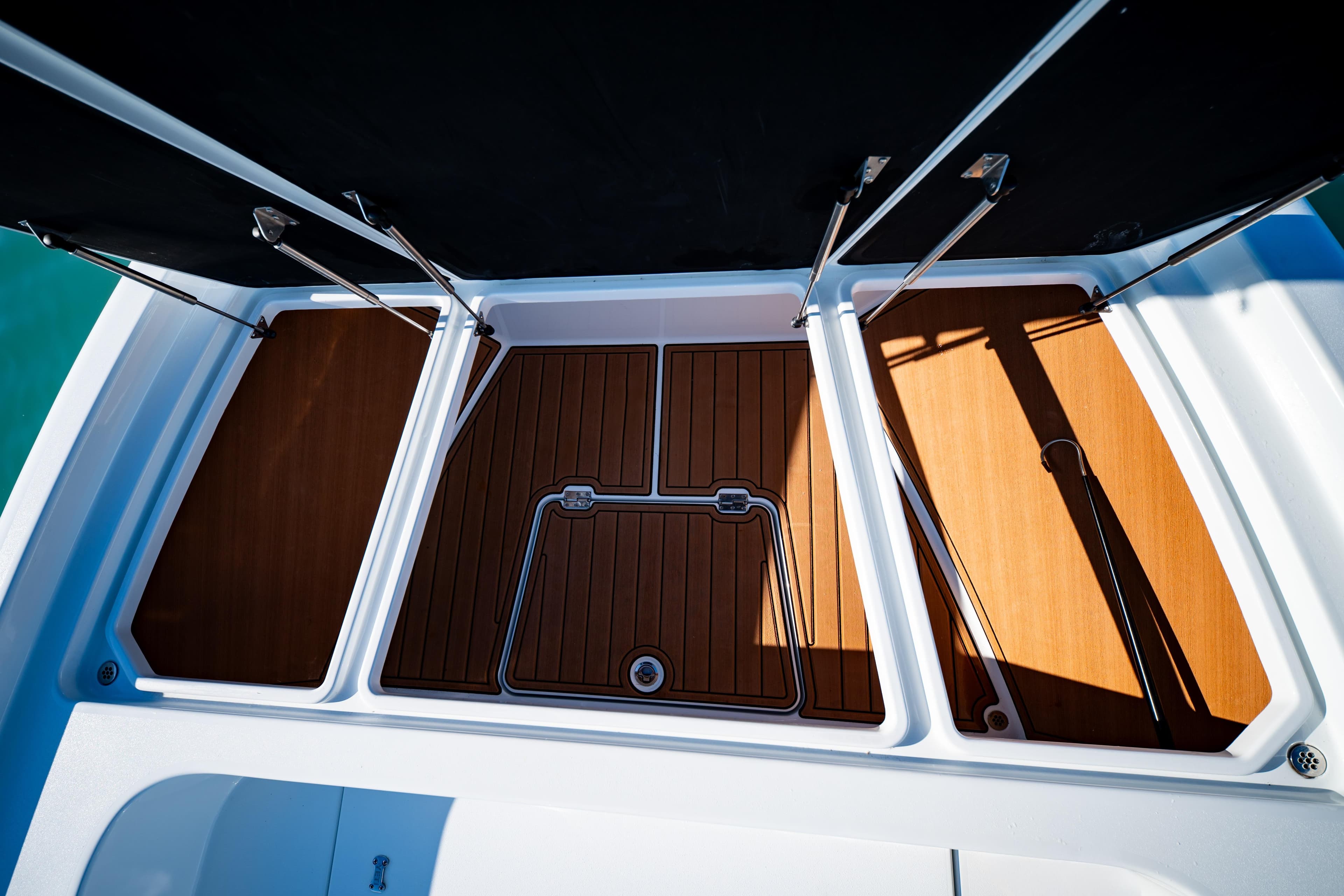 2016 Barker Boatworks 26 Calibogue Bay deck with open storage compartments.
