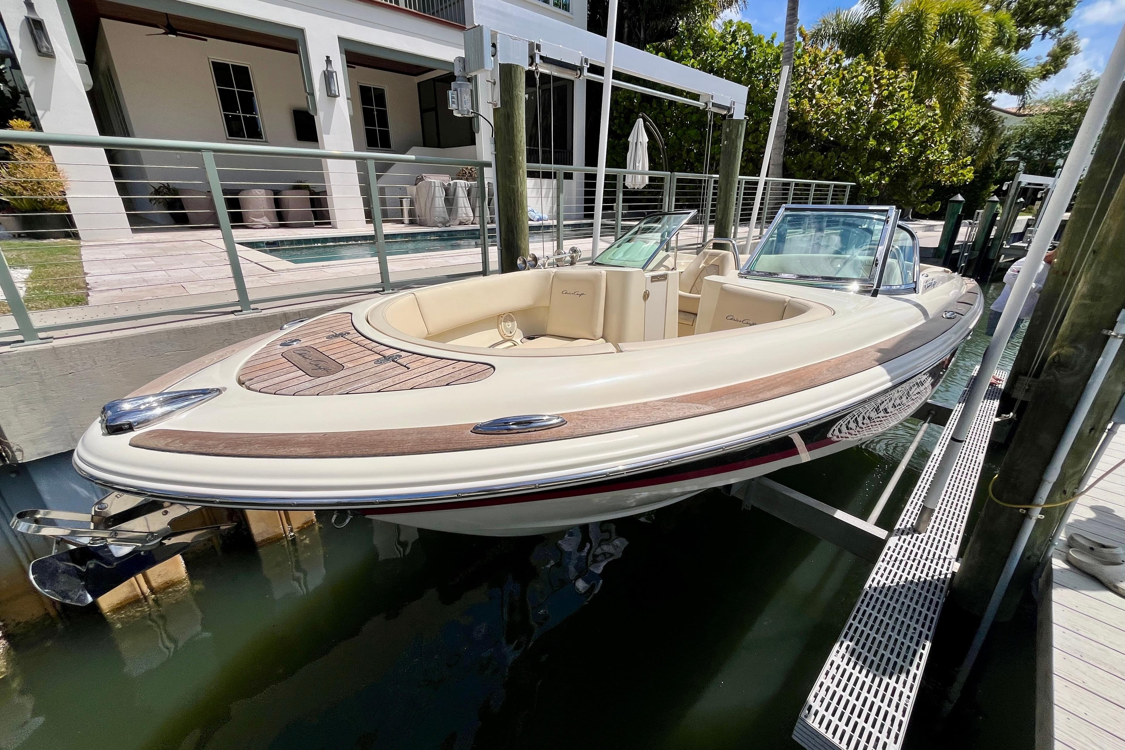 2019 Chris-Craft Launch 27 boat docked, showcasing elegant design and luxurious seating.