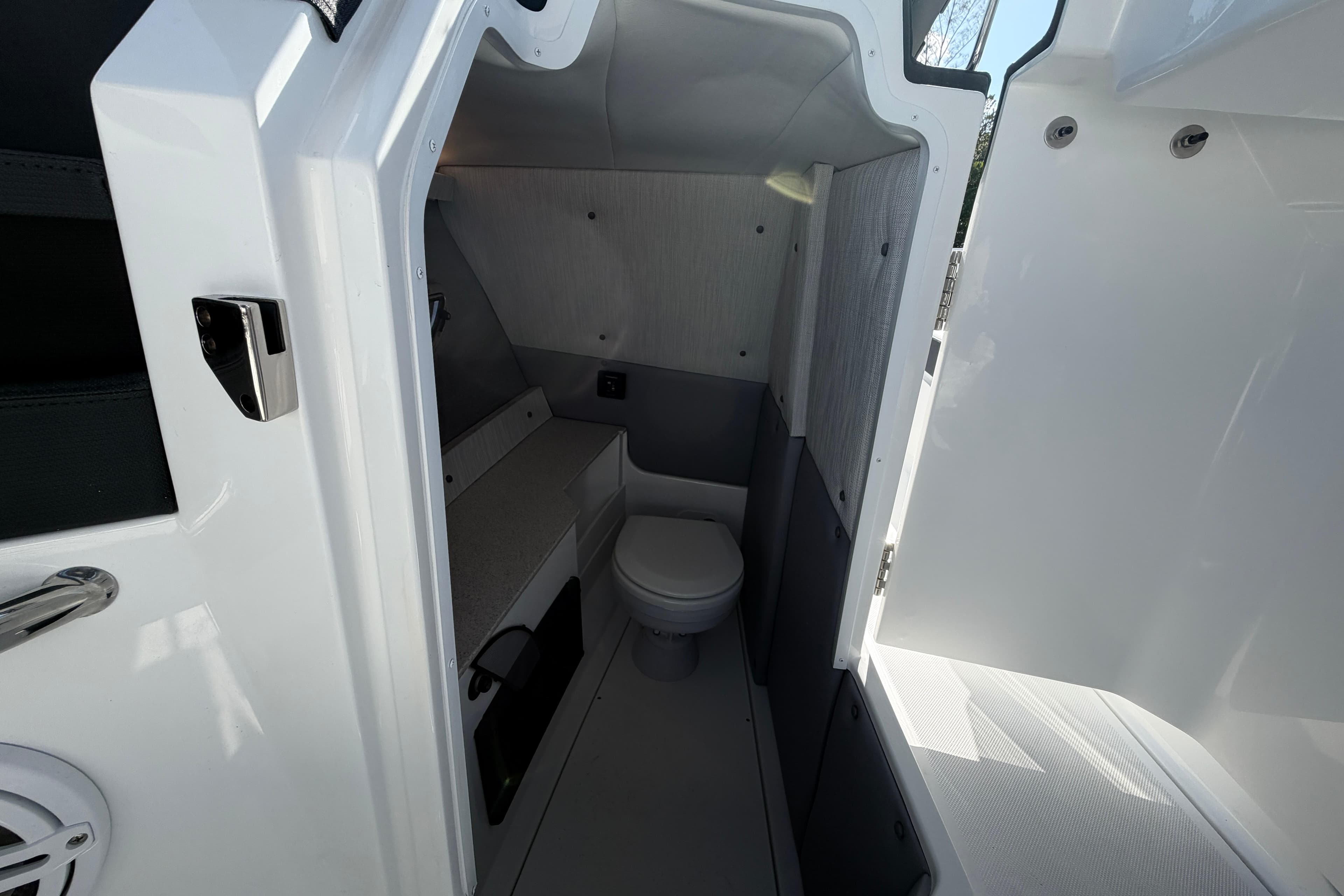 Interior of 2026 Cobalt R8 Outboard boat featuring a compact bathroom.