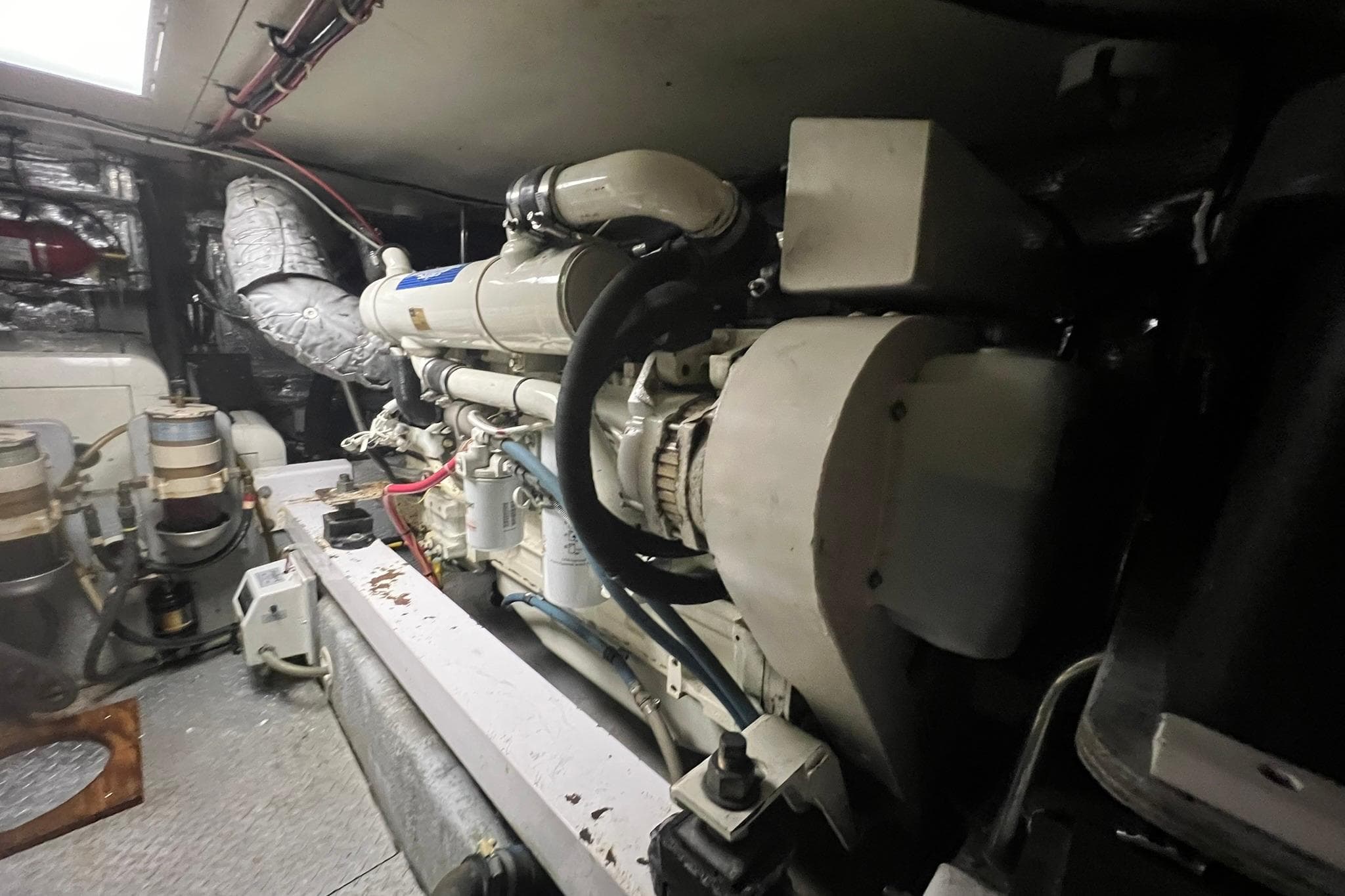 Engine room of a 2000 Silverton 453 Motor Yacht, showcasing mechanical components.