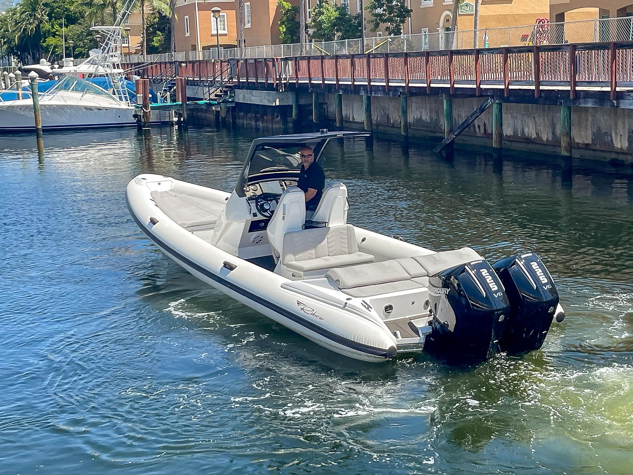 2025 Ribco Venom 30 boat with dual engines cruising in a marina.