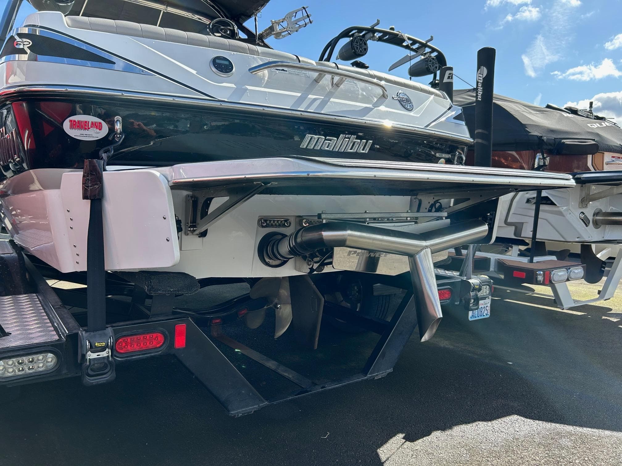 2013 Malibu Wakesetter 20 VTX boat rear view with trailer, sunny day.
