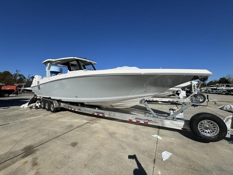 2024 Fountain 38 SCX boat on a trailer in a marina.