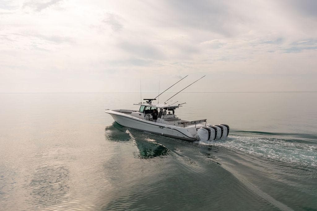2019 HCB 53 boat cruising on calm water under a cloudy sky.