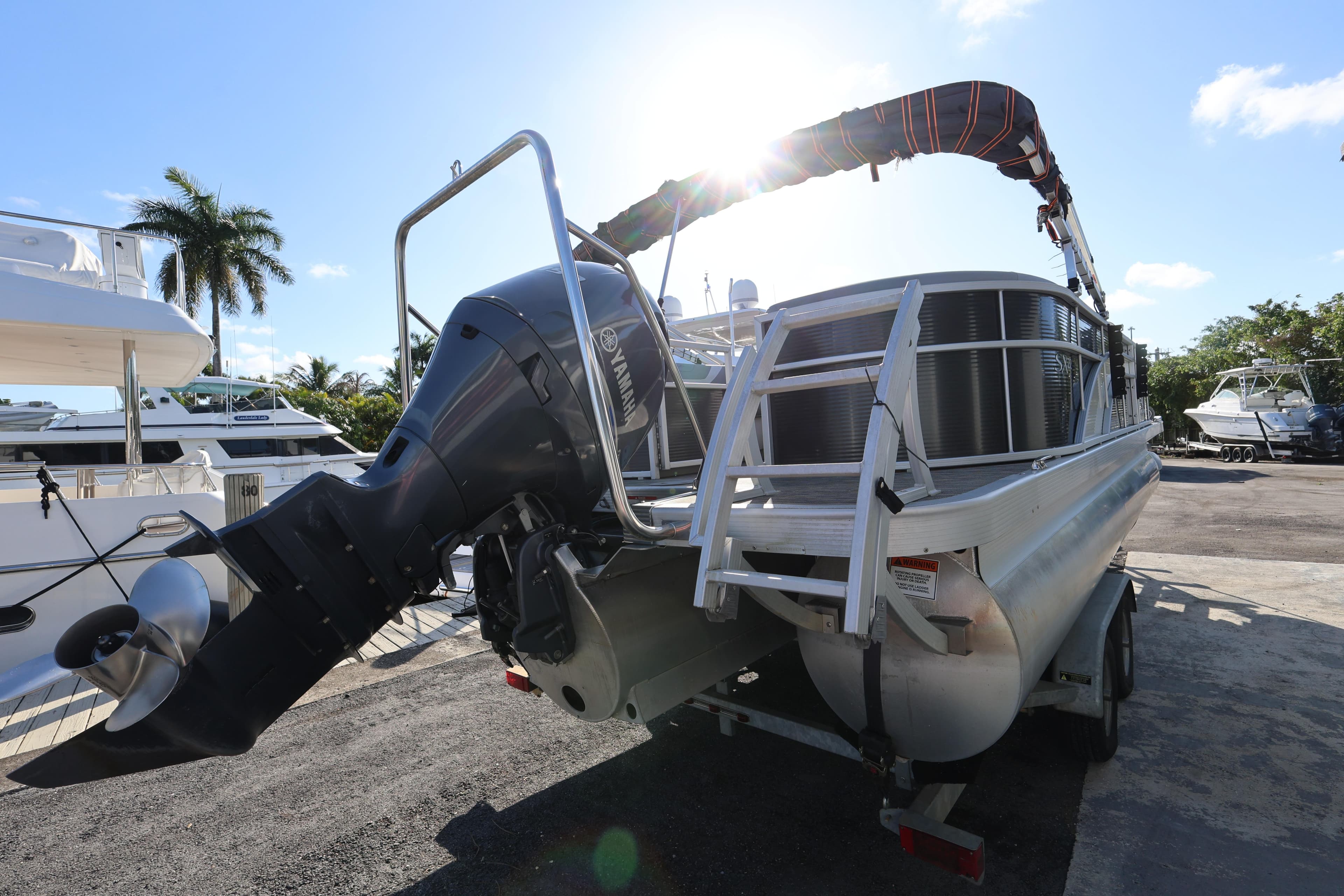 2020 Bennington SX 22 SSRX pontoon boat with Yamaha outboard motor, docked under sunny skies.