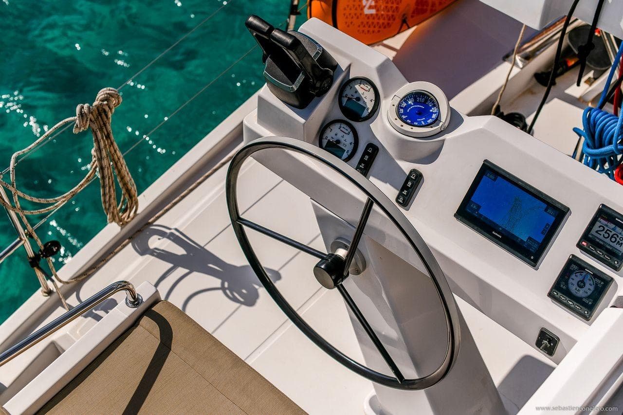 Helm of 2026 Aventura Yachts 37 DC with navigation instruments and steering wheel.