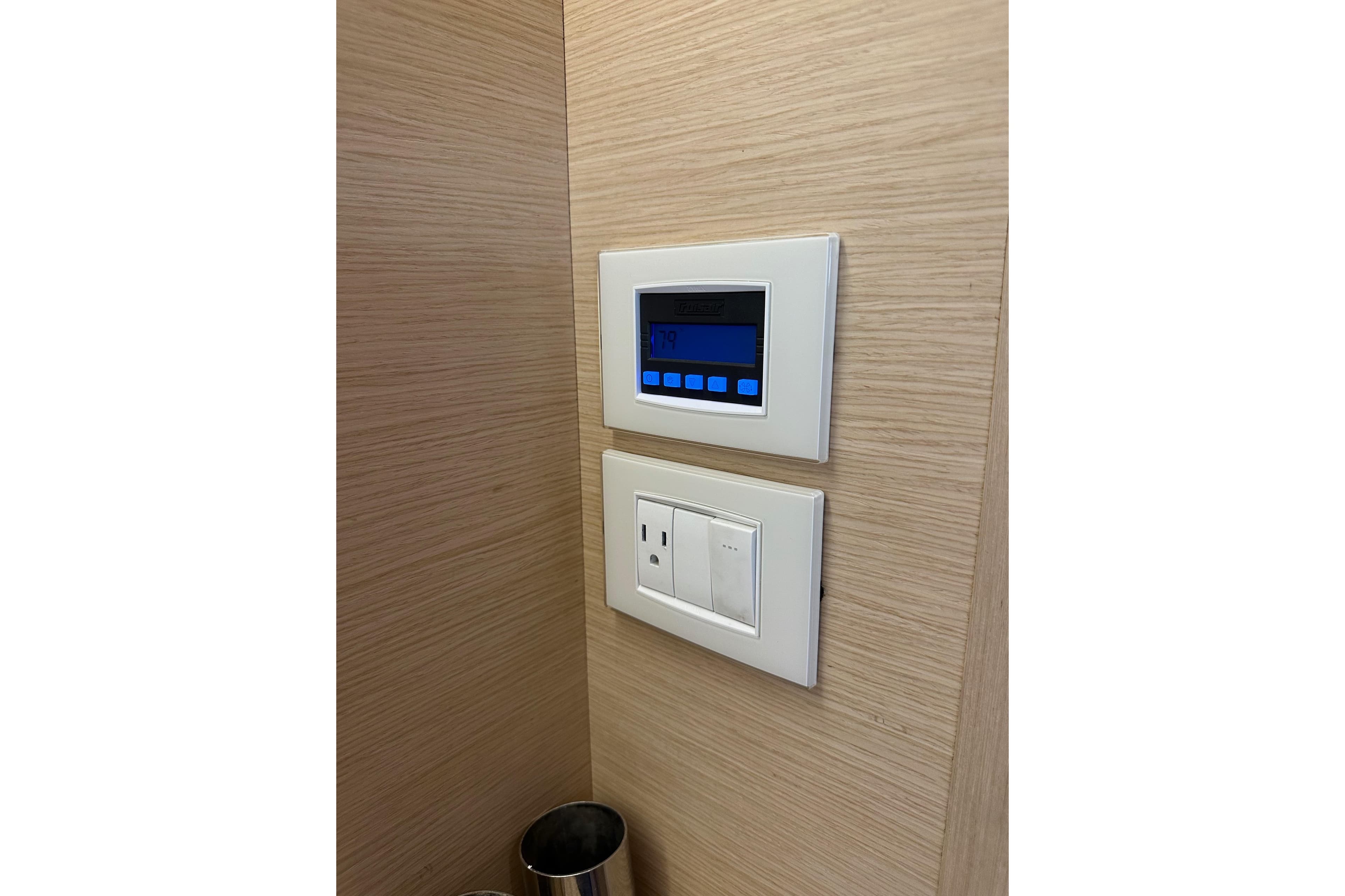 Control panel and outlet on Jeanneau 54 yacht, 2018 model, wooden interior.